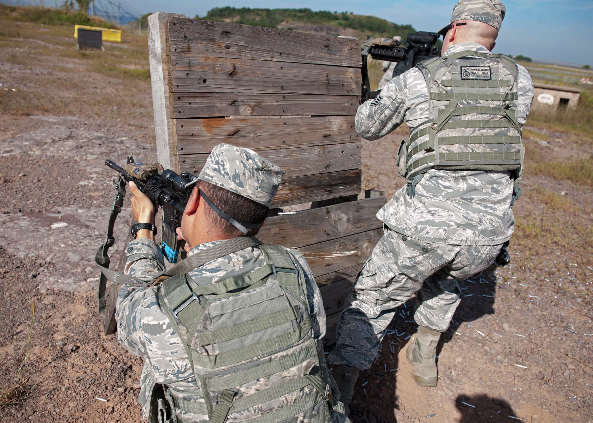 Airman 1st Class Anibal Roldanflores (left), and Staff Sgt. Travis Bledsoe, 8th Security Forces Squadron response force members, practice “shoot-move and communicate” skills during combat readiness training Sept. 16 at Kunsan Air Base, Republic of Korea. As Kunsan’s first line of defense, security forces members must accurately and effectively perform their tactical capabilities in order to defend against external threats in wartime and armistice. (U.S. Air Force photo/Senior Airman Katrina Heikkinen)