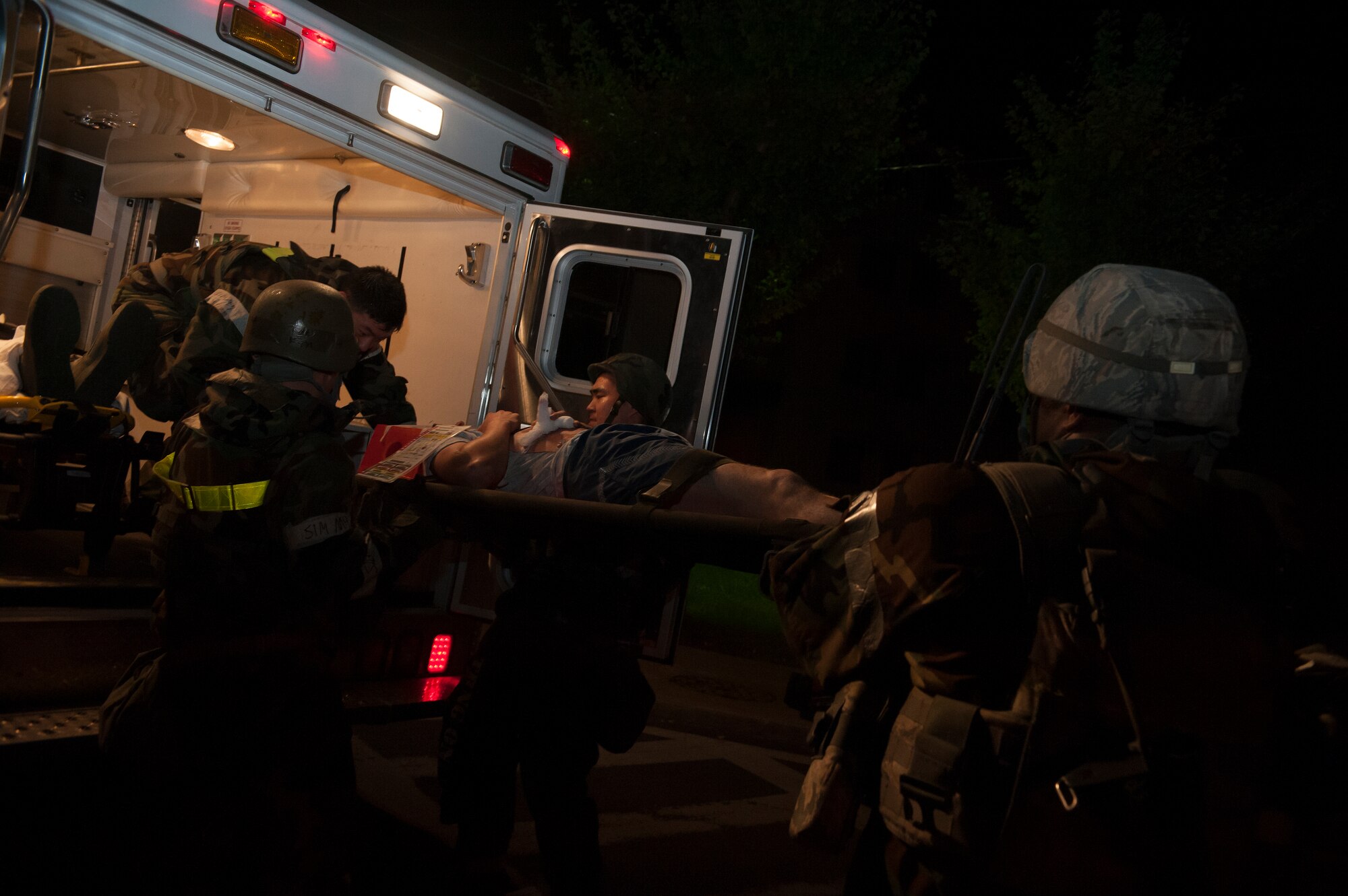 Medics from the 51st Medical Group lift a wounded victim into an ambulance during a mass casualty exercise at Osan Air Base, Republic of Korea, Sept.17, 2014. The exercise helps identify areas in which procedures should be changed or equipment added in order to enhance the emergency response capabilities. (U.S. Air Force photo by Senior Airman Matthew Lancaster)