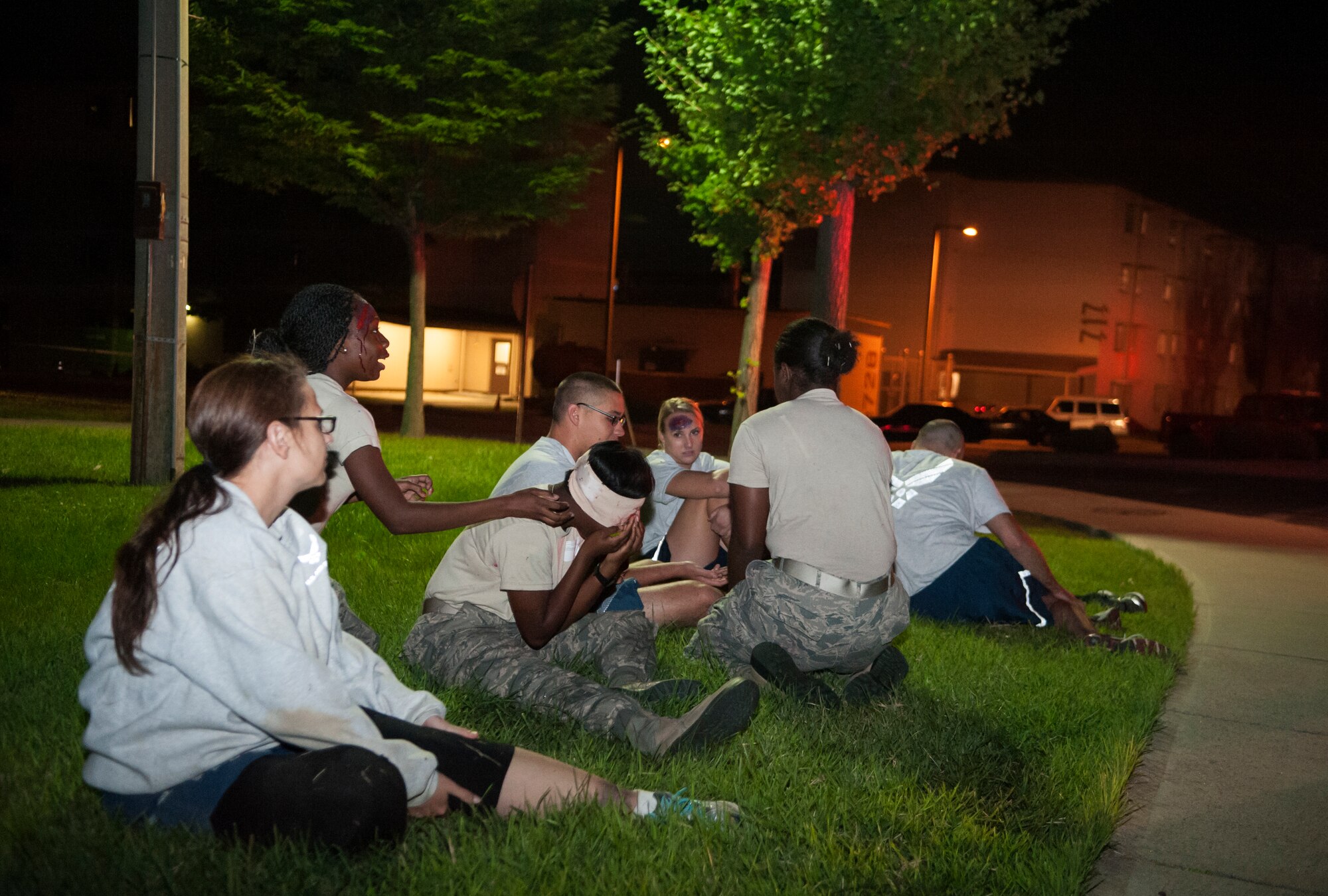 Wounded victims wait for medical attention during a mass casualty exercise at Osan Air Base, Republic of Korea, Sept.17, 2014. Each Airman was given a set of physical and/or mental injuries to portray as a result of indirect fire on Bldg. 745.(U.S. Air Force photo by Senior Airman Matthew Lancaster)
