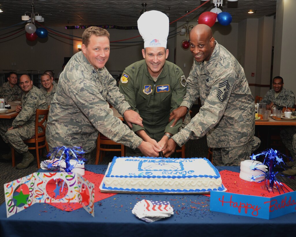 Brig. Gen Andrew Toth, 36th Wing commander, Col. Tyrell Chamberlain, 36th Wg vice commander and Chief Master Sgt. Michael McMillan, 36 Wg command chief,  cuts a cake during the 67th Air Force birthday celebration at the Top of The Rock dining facility Sept. 18, 2014, on Andersen Air Force Base, Guam. The cake cutting celebrates the creation of the U.S. Air Force as an independent service in 1947, when the Air Force separated from the U.S. Army. (U.S. Air Force photo by Senior Airman Cierra Presentado/Released)