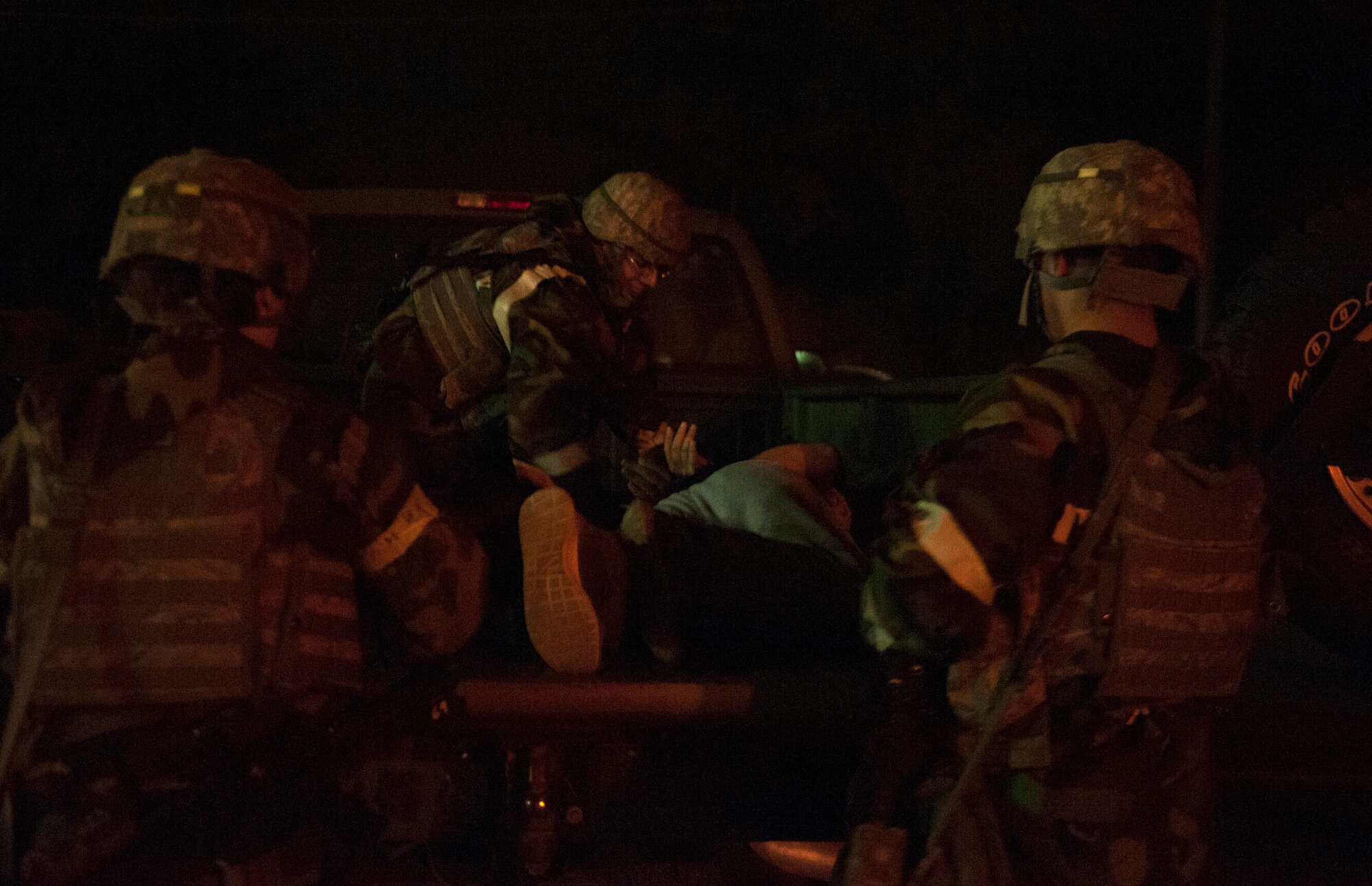 Members from the 51st Security Forces Squadron put a detained opposition forces member into a truck Sept.17, 2014, Osan Air Base, Republic of Korea. Any oppositon forces still alive after the battle are taken into custody by SFS members. (U.S. Air Force photo by Senior Airman Matthew Lancaster)