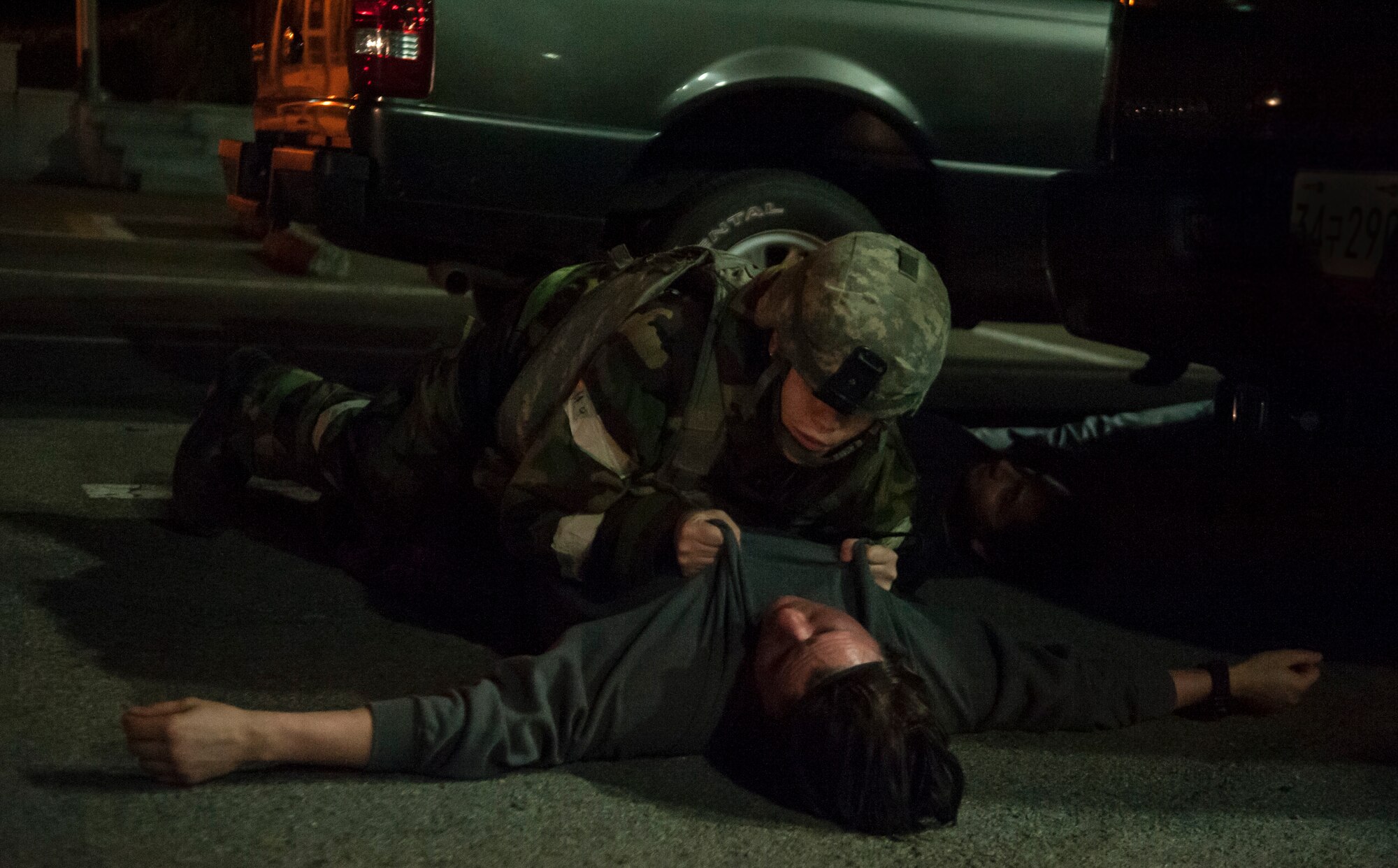 A 51st Security Forces Squadron member performs a roll over body check on a dead opposition forces member during Operational Readiness Exercise Beverly Midnight 14-4 Sept. 17, 2014, at Osan Air Base, Republic of Korea. This check is done to make sure the body is not wired with explosives. (U.S. Air Force photo by Senior Airman Matthew Lancaster)