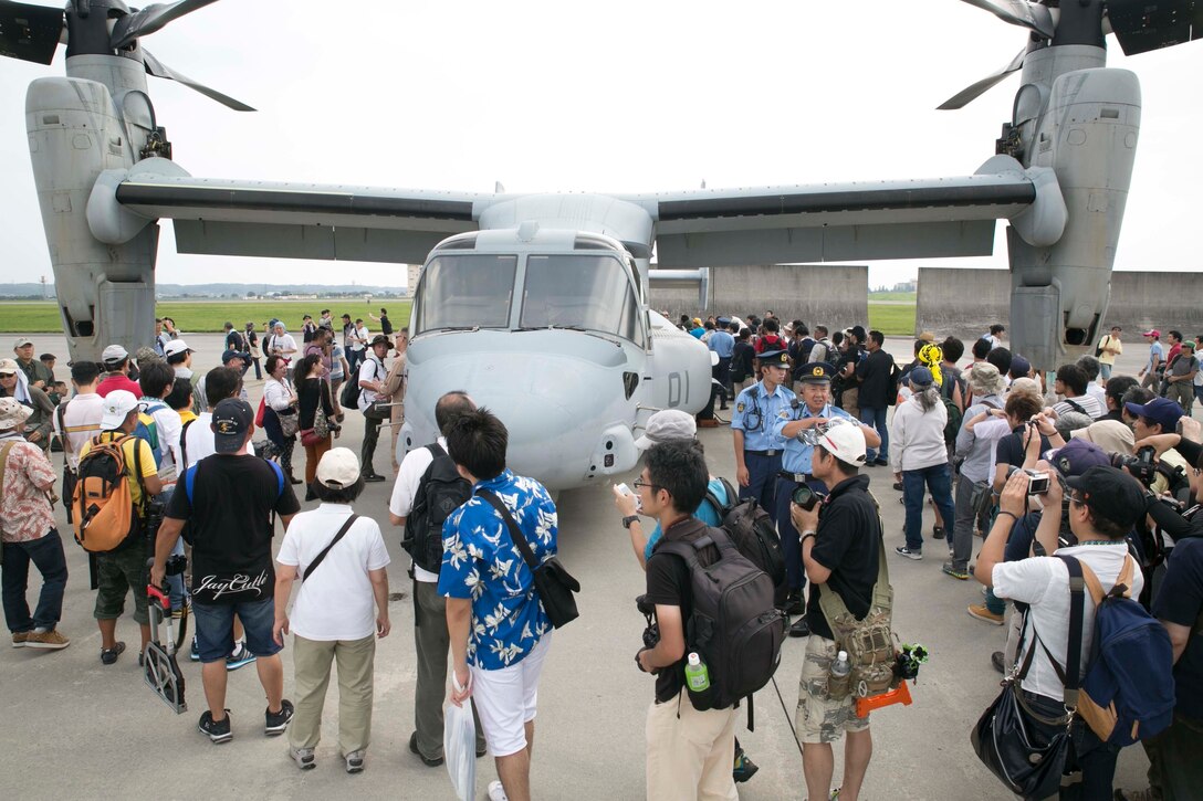 A crowd forms around an MV-22B Osprey tiltrotor aircraft Sept. 5 at the Japanese-American Friendship Festival on Yokota Air Base. More than 148,000 people attended the festival, where the Osprey was one of the most popular aircraft. Festival attendees waited in line for the chance to walk through the Osprey at its debut. The Osprey is assigned to Marine Medium Tiltrotor Squadron 265, Marine Aircraft Group 36, 1st Marine Aircraft Wing, III Marine Expeditionary Force. (U.S. Marine Corps Photo by Cpl. Thor J. Larson/Released)