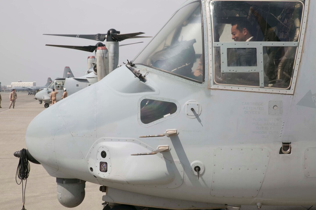 Shinji Inoue sits in the cockpit of an MV-22B Osprey tiltrotor aircraft at Yokota Air Base Sept. 5 before the opening of the Japanese-American Friendship Festival. Inoue, a member of the Japan House of Representatives, was a special guest who was given a tour of the Osprey the day before the festival. More than 148,000 people attended the festival where there were displays of both U.S. military and Japan Air Self-Defense Force Aircraft. This year marked the first time the Osprey was displayed at the festival. The Osprey is assigned to Marine Medium Tiltrotor Squadron 265, Marine Aircraft Group 36, 1st Marine Aircraft Wing, III Marine Expeditionary Force. (U.S. Marine Corps Photo by Cpl. Thor J. Larson/Released)