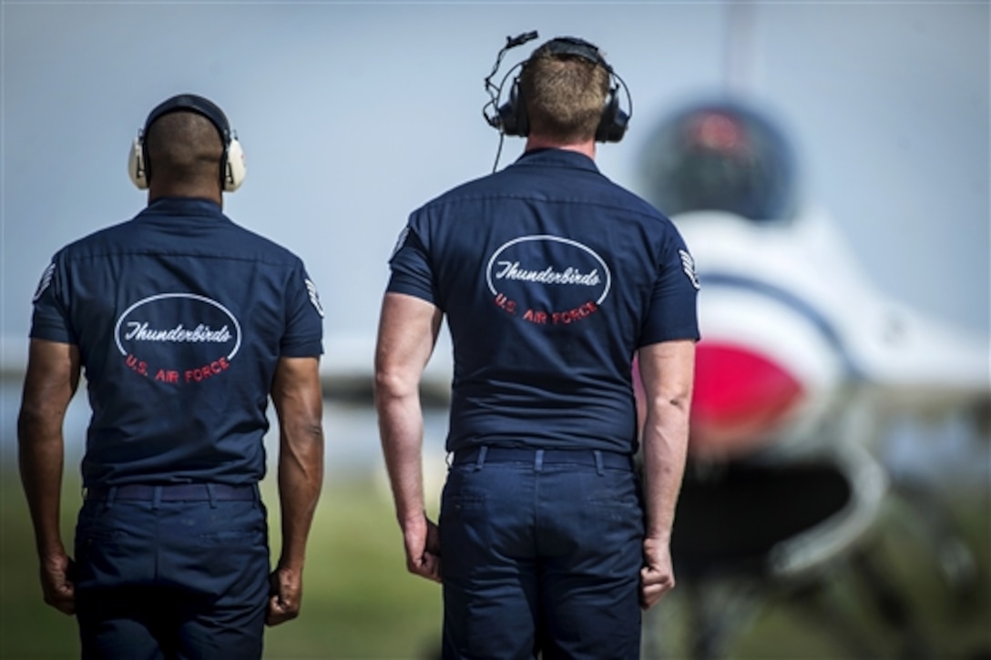 Members of the U.S. Air Force Thunderbirds maintenance team prepare to marshal a jet during the Wings of Freedom Open House on Altus Air Force Base, Okla., Sept. 13, 2014.