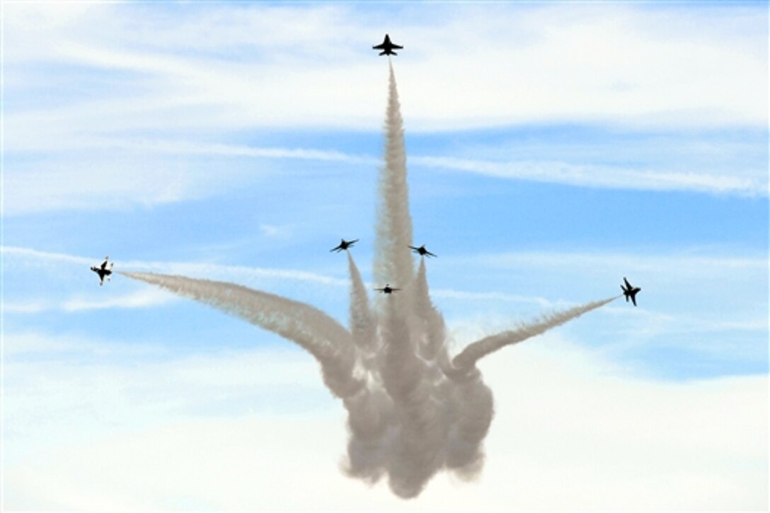 The U.S. Air Force Thunderbirds perform a delta burst maneuver during the Wings of Freedom Open House on Altus Air Force Base, Okla., Sept. 13, 2014. 