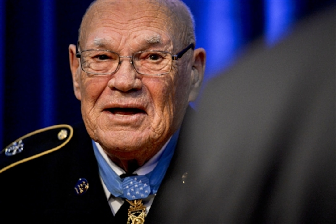 Medal of Honor recipient, retired Army Command Sgt. Maj. Bennie G. Adkins, tells a joke before Defense Secretary Chuck Hagel inducts him into the Hall of Heroes during a ceremony at the Pentagon, Sept. 16, 2014.