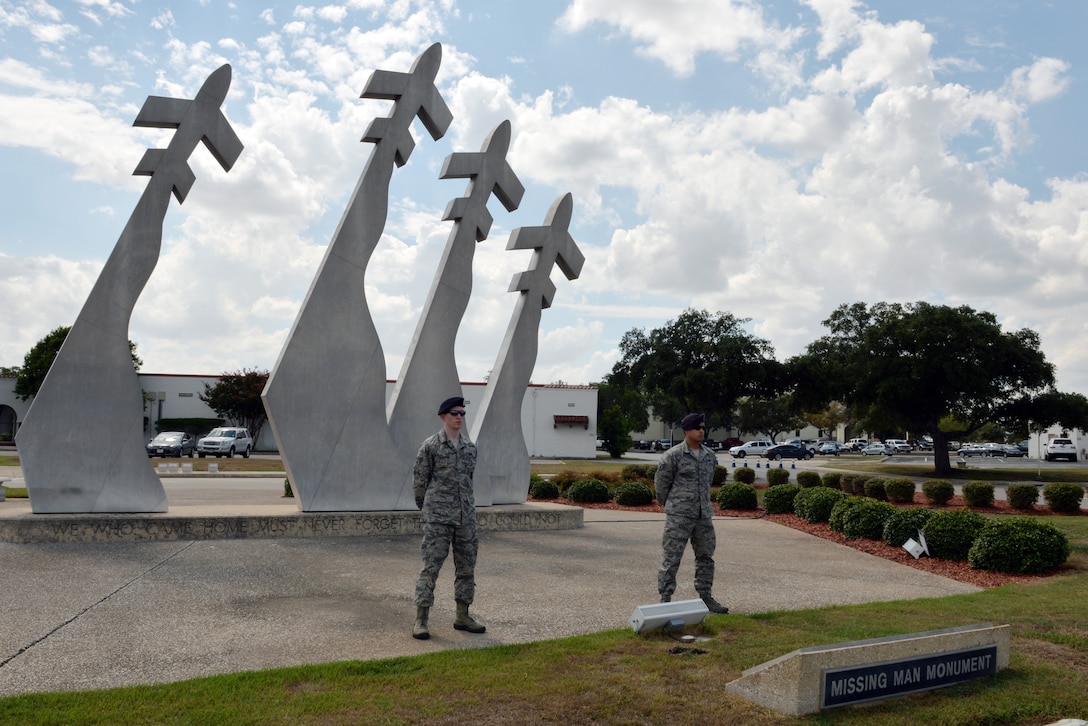 Senior Airman Kelly Sowards, left, and Staff Sgt. Joshua McKinnon, right, stand guard at the Missing Man Monument to pay respect to Prisoners of War and Missing in Action Sept. 18 at Joint Base San Antonio-Randolph. Sowards and McKinnon are assigned to the 902nd Security Forces Squadron. (U.S. Air Force photo/Desiree N. Palacios)