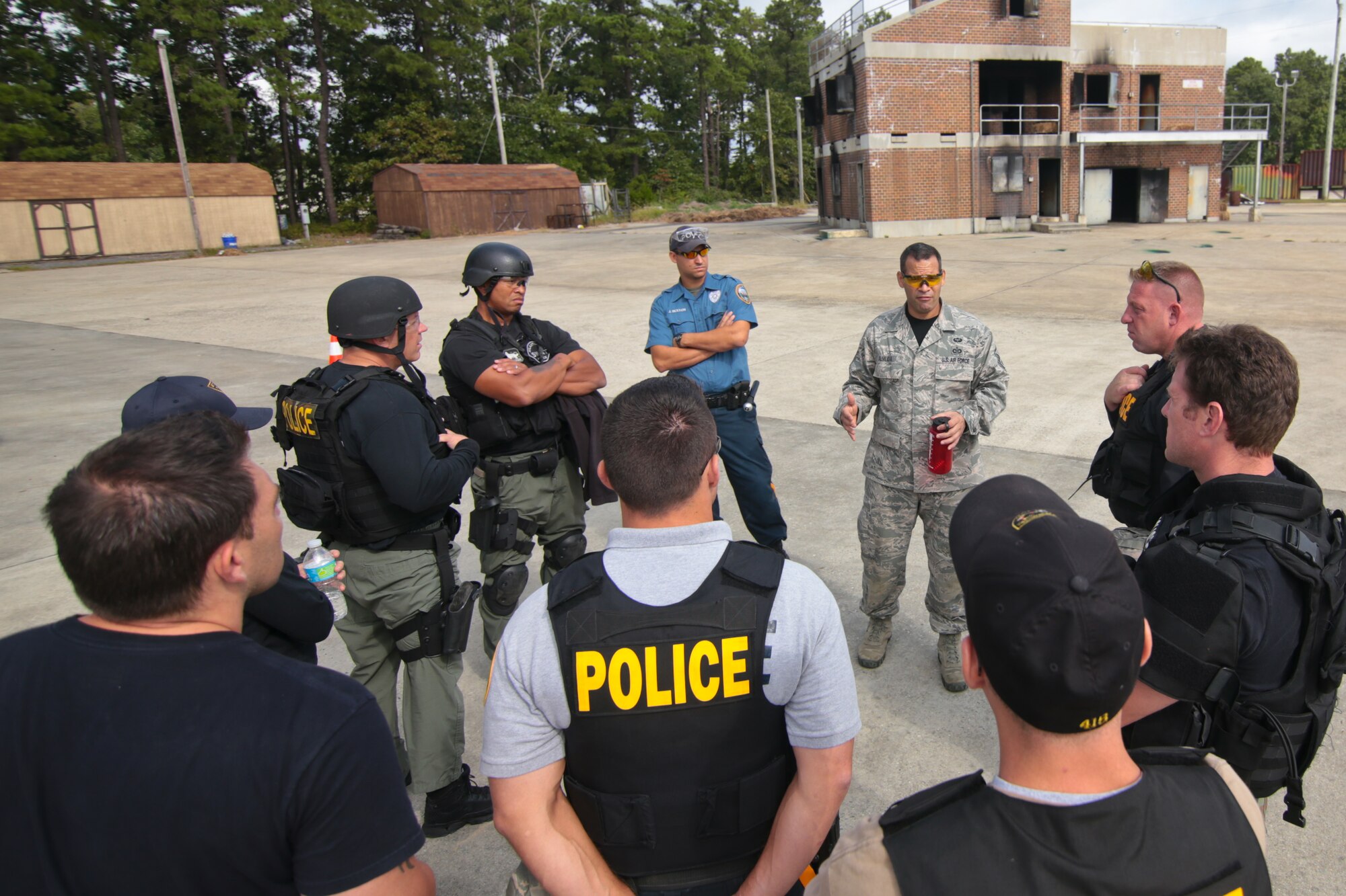 A picture of U.S. Air Force Master Sgt. Jose Almeida instructing law enforcement officers on various ways to carry injured people during Tactical Combat Casualty Care training.