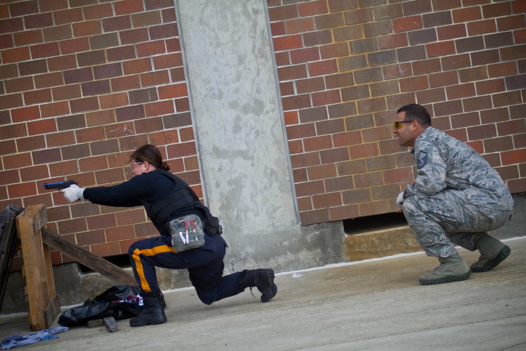 A picture of New Jersey State Trooper Dianna Wamsher firing sim rounds at targets.