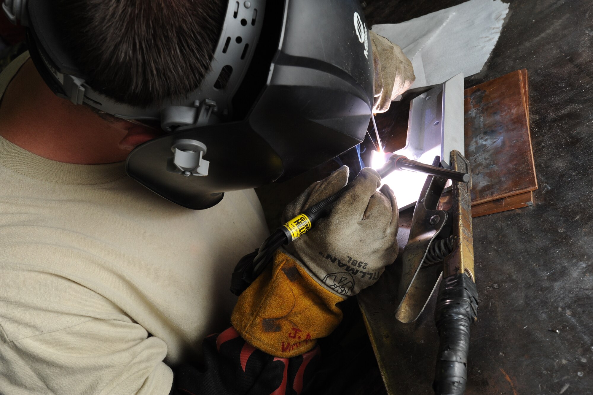 Tech. Sgt. Josh Dinger, a 440th Maintenance Squadron metals fabrication craftsman, uses a Tungsten Inert Gas welder to repair a C-130 cargo bracket at Pope Field on Aug. 6, 2014.  Metals technicians use mills, lathes, welders and hand tools to create functional aircraft components out of pieces of stock metal, said Dinger.  (U.S. Air Force photo by Tech. Sgt. Peter R. Miller)