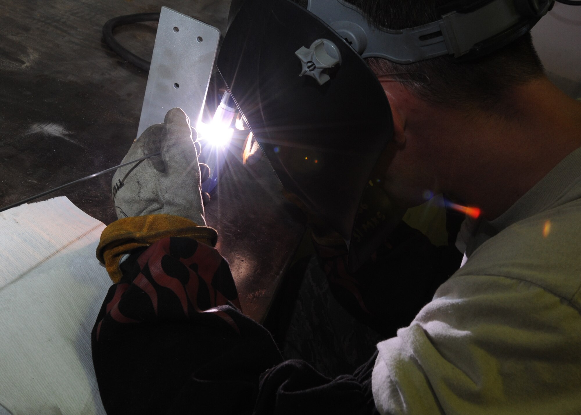 Tech. Sgt. Josh Dinger, a 440th Maintenance Squadron metals fabrication craftsman, uses a Tungsten Inert Gas welder to repair a C-130 cargo bracket at Pope Field on Aug. 6, 2014.  Metals technicians use mills, lathes, welders and hand tools to create functional aircraft components out of pieces of stock metal, said Dinger.  (U.S. Air Force photo by Tech. Sgt. Peter R. Miller)