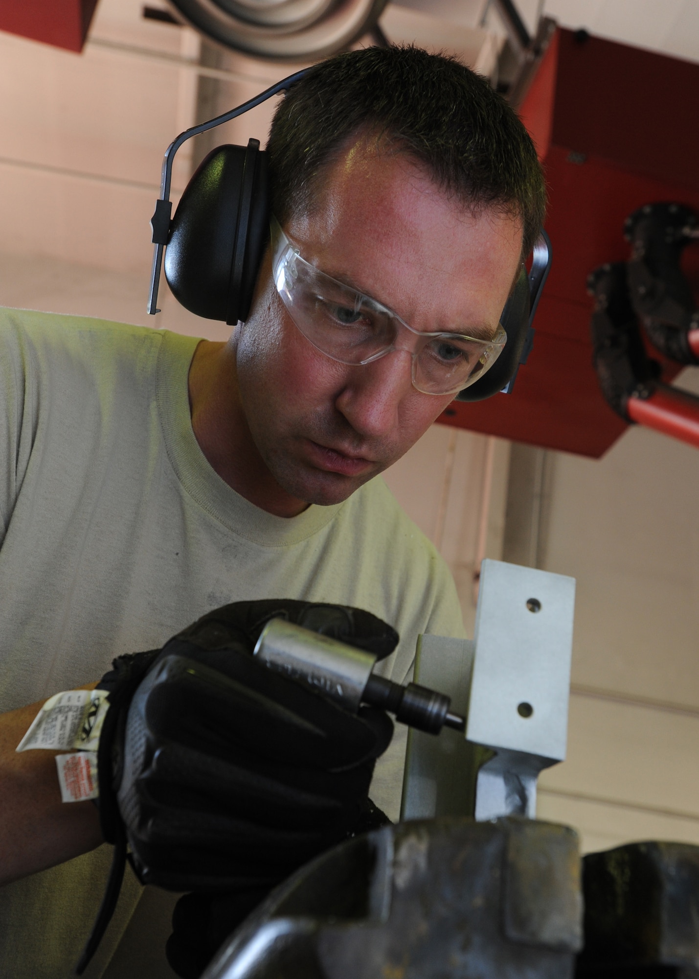 Tech. Sgt. Josh Dinger, a 440th Maintenance Squadron metals fabrication craftsman, uses a die grinder to removed cracked material from a C-130 cargo bracket while preparing it for repair at Pope Field on Aug. 6, 2014.  Metals technicians use mills, lathes, welders and hand tools to create functional aircraft components out of pieces of stock metal, said Dinger.  (U.S. Air Force photo by Tech. Sgt. Peter R. Miller)
