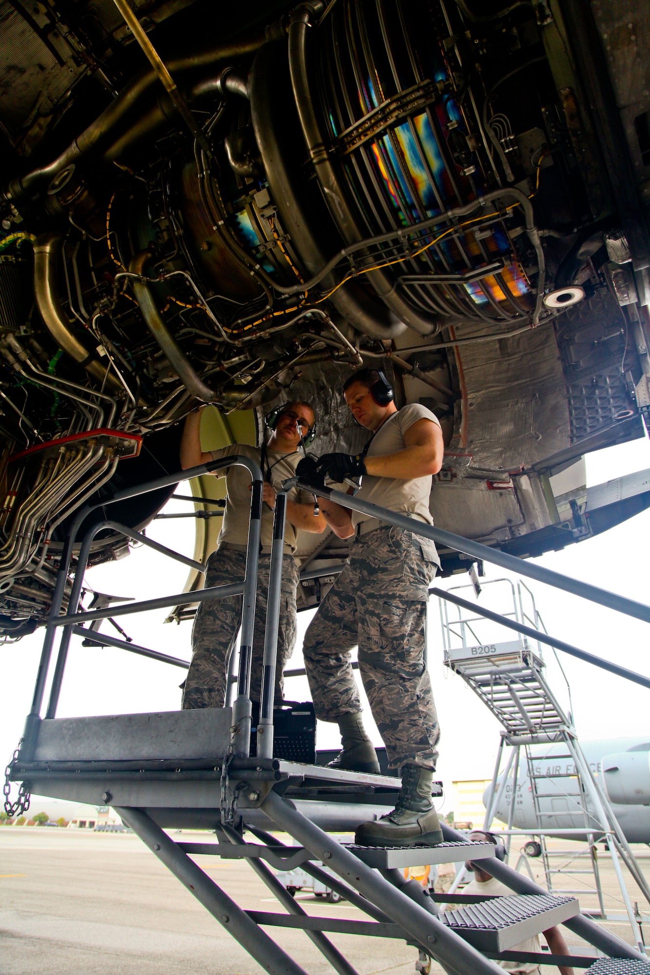 Tech. Sgt. Eric Overkamp (left) and Senior Airman Andrew Robinson, both 315th Aircraft Maintenance Squadron members here at Joint Base Charleston, S.C., repair a C-17 Globemaster III engine yesterday on the flight line here at Joint Base Charleston, S.C. Overkamp and Robinson provided maintenance support along with other 315th MXG members yesterday while the 437th Maintenance Group took part in the active duty’s wingman day activities. (U.S. Air Force photo by Staff Sgt. Rashard Coaxum)