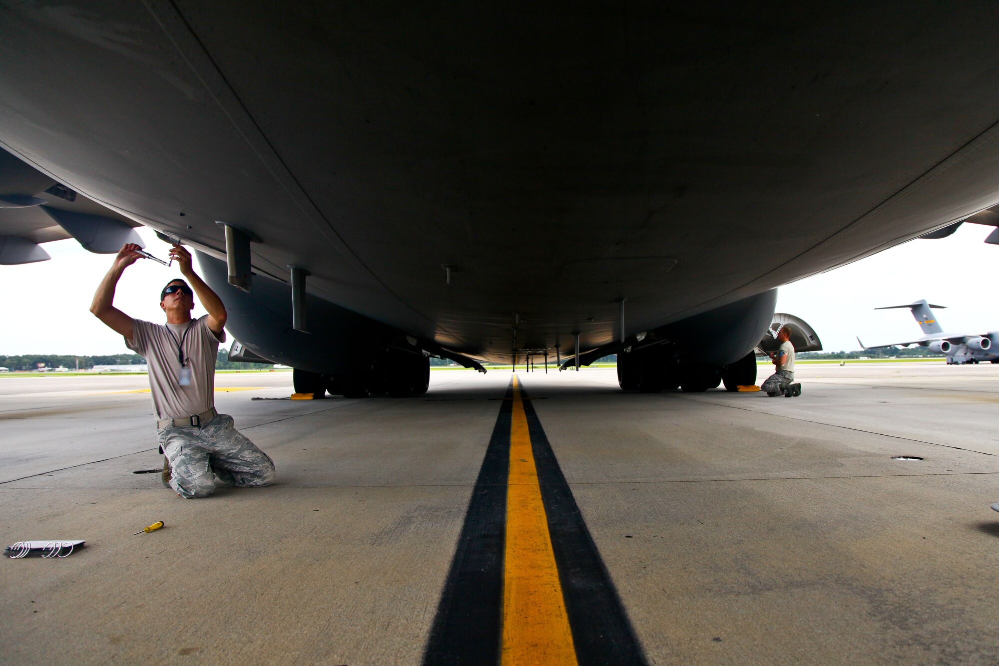 Tech. Sgts. Shawn Summers (left) and Brad Beames finish maintenance repairs on a C-17 Globemaster III yesterday on the flight line here at Joint Base Charleston, S.C. Summers and Beames are 315th Maintenance Group members who provided maintenance support along with other 315th MXG members yesterday while the 437th Maintenance Group took part in the active duty’s wingman day activities. (U.S. Air Force photo by Staff Sgt. Rashard Coaxum)