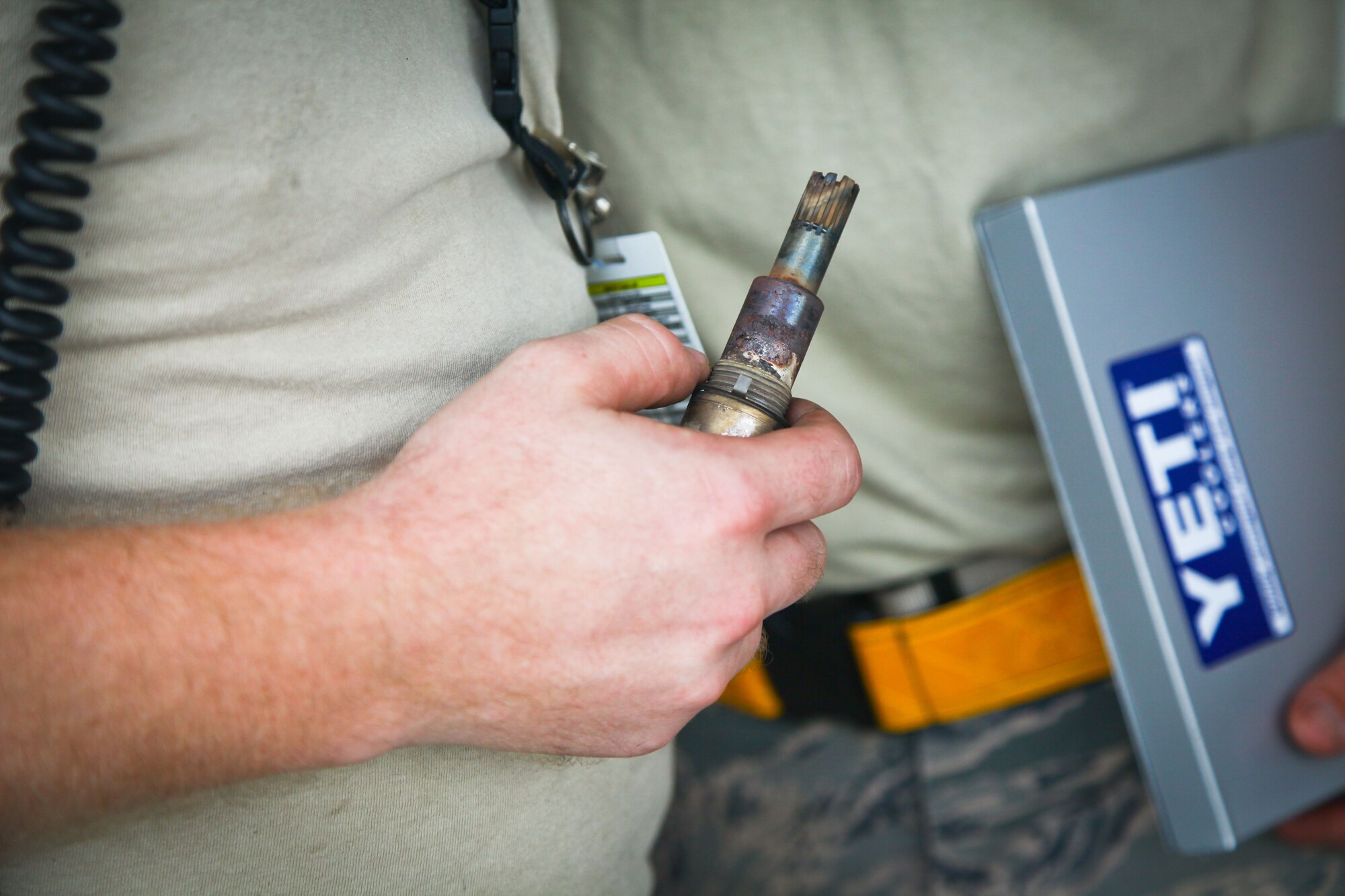 Tech. Sgt. Eric Overkamp, a member of the 315th Maintenance Group here at Joint Base Charleston, S.C., holds a C-17 Globemaster III engine spark plug after removing it during a post flight maintenance check yesterday on the aircraft ramp here. Overkamp provided maintenance support along with other 315th MXG members yesterday while the 437th Maintenance Group took part in the active duty’s wingman day activities.  (U.S. Air Force photo by Staff Sgt. Rashard Coaxum)