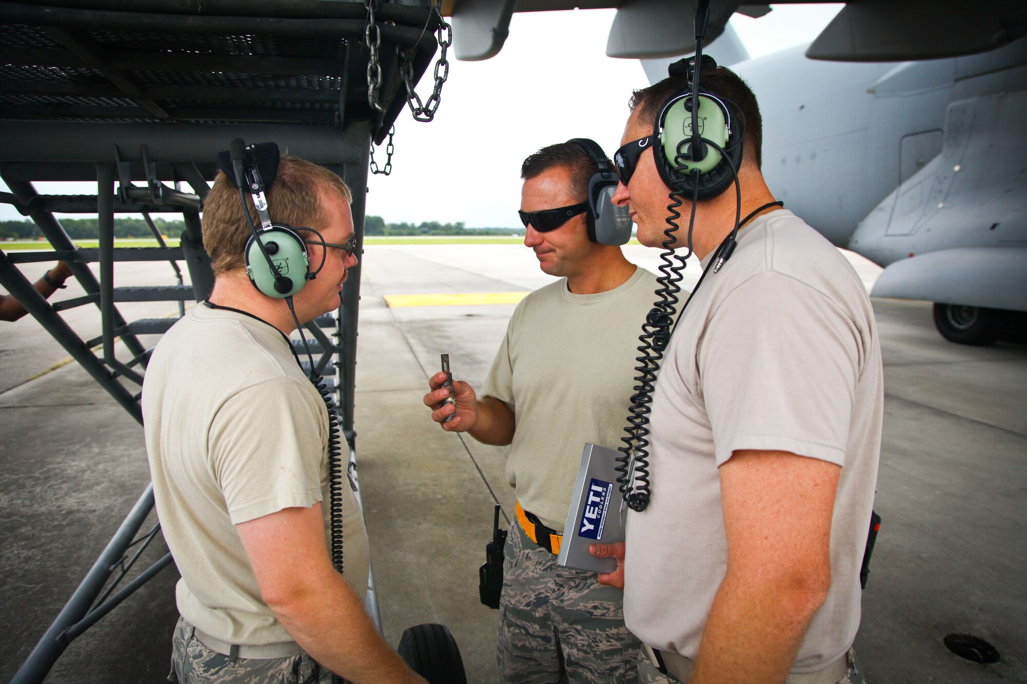 Master Sgt. Jeremy Davis (center), 315th Aircraft Maintenance Squadron production superintendant, looks at a damaged spark plug that was removed from the engine of a C-17 Globemaster III yesterday during maintenance checks with Tech. Sgt. Eric Overkamp (left) and Senior Airman Andrew Robinson (right). The 315th AMXS provided maintenance support along with other 315th MXG members yesterday while the 437th Maintenance Group took part in the active duty’s wingman day activities. (U.S. Air Force photo by Staff Sgt. Rashard Coaxum)