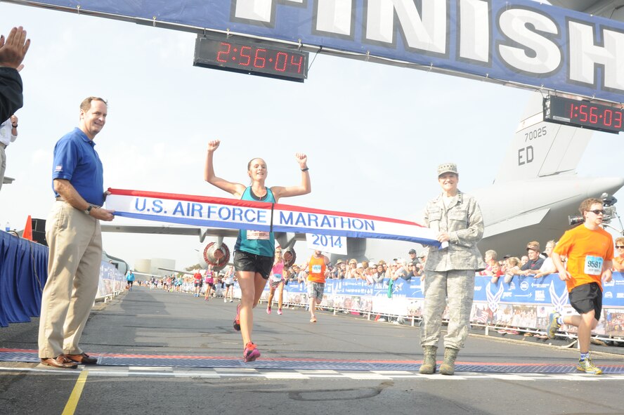 Nicoloa Holdsworth, winner of the 2014 U.S. Air Force womens full marathon, crosses the finish line at Wright-Patterson Air Force Base Sept. 20. "It was all adrenaline at the end," said Holdsworth. This was her first marathon win. (U.S. Air Force photo by Wes Farnsworth).