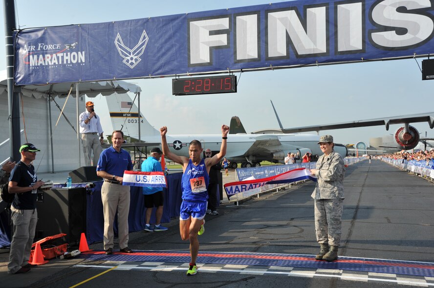 Steve Chu, Colorado Springs, Colo., crosses the finish line as the 2014 U.S. Air Force Marathon Men's full marathon champion at Wright-Patterson Air Force Base, Ohio, Sept 20. "I wanted to win this for my wife," said Chu, whose wife is an active duty Air Force major. (U.S. Air Force photo by Mike Libecap)