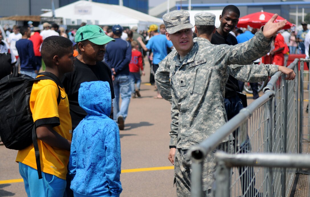 Army Spc. Joe Zuwiyya, New York National Guard, answers questions for guests at Africa's largest air show Sept. 20, 2014. Griffith and a total force team of U.S. Air Force Airmen and U.S. Army Soldiers attended the Africa Aerospace & Defence Expo 2014 at Waterkloof Air Force Base, South Africa, to showcase the United States' commitment to its partnership with South Africa. (U.S. Air Force photo by Tech. Sgt. Austin M. May/Released)