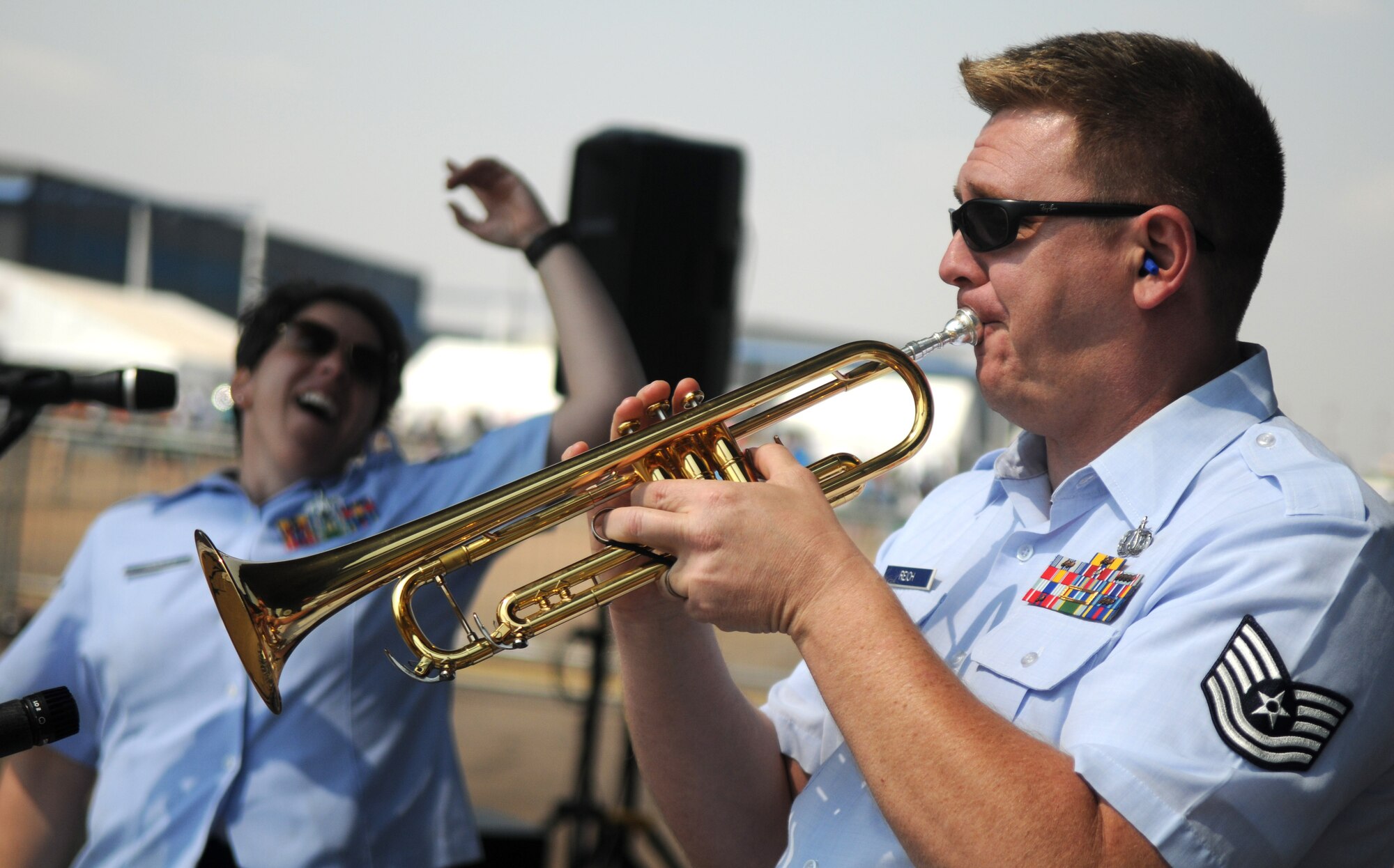 Tech. Sgt. Jeff Reich, trumpeter, and the United States Air Forces in Europe jazz band, Wings of Dixie, perform beneath the wing of a New York Air National Guard C-17 Globemaster III at Africa's largest air show Sept. 20, 2014. A total force team of U.S. Air Force Airmen and U.S. Army Soldiers attended the Africa Aerospace & Defence Expo 2014 at Waterkloof Air Force Base, South Africa, to showcase the United States' commitment to its partnership with South Africa. (U.S. Air Force photo by Tech. Sgt. Austin M. May/Released)