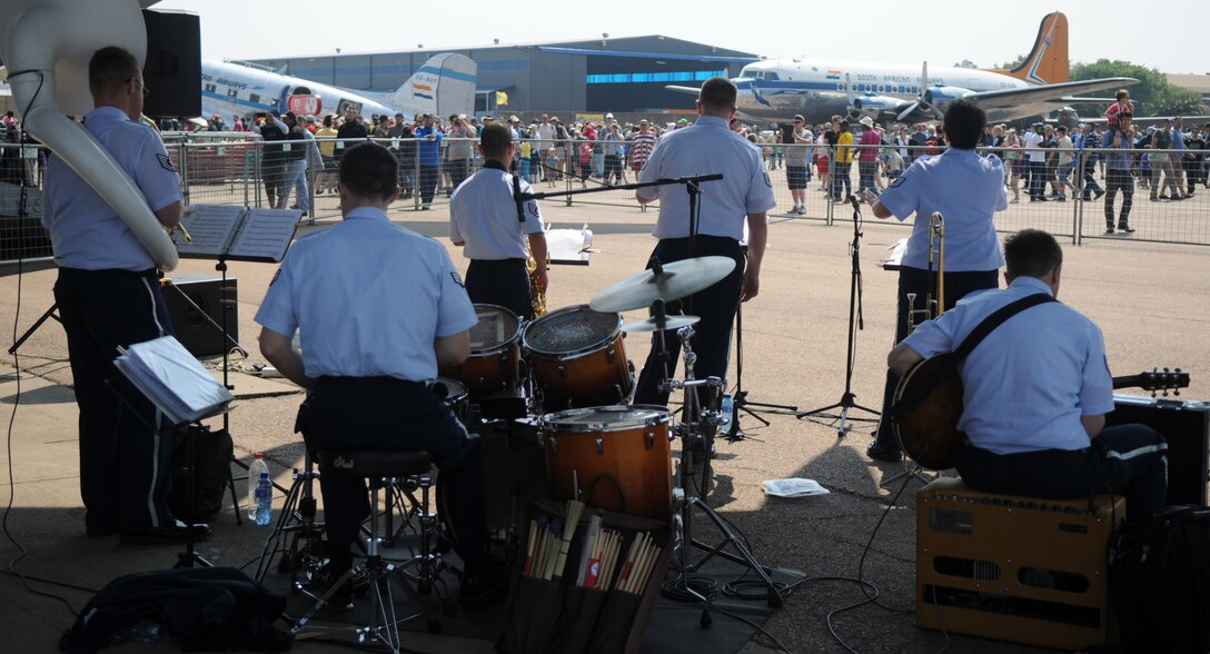 The United States Air Forces in Europe jazz band, Wings of Dixie, perform beneath the wing of a New York Air National Guard C-17 Globemaster III at Africa's largest air show Sept. 20, 2014. A total force team of U.S. Air Force Airmen and U.S. Army Soldiers attended the Africa Aerospace & Defence Expo 2014 at Waterkloof Air Force Base, South Africa, to showcase the United States' commitment to its partnership with South Africa. (U.S. Air Force photo by Tech. Sgt. Austin M. May/Released)