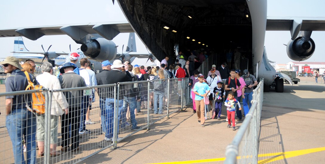 Guests wait to board a C-17 Globemaster III at Africa's largest air show Sept. 20, 2014. A total force team of U.S. Air Force Airmen and U.S. Army Soldiers attended the Africa Aerospace & Defence Expo 2014 at Waterkloof Air Force Base, South Africa, to showcase the United States' commitment to its partnership with South Africa. (U.S. Air Force photo by Tech. Sgt. Austin M. May/Released)
