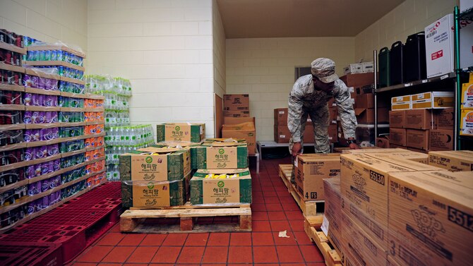 Senior Airman Mark Harshaw, 8th Force Support Squadron dining facility storeroom assistant, organizes boxes of dry foods at Kunsan Air Base, Republic of Korea, July 10, 2014. Organization of the storeroom is important, mainly to ensure every item can be tracked correctly before being distributed to the customers. (U.S. Air Force photo by Senior Airman Taylor Curry/Released)