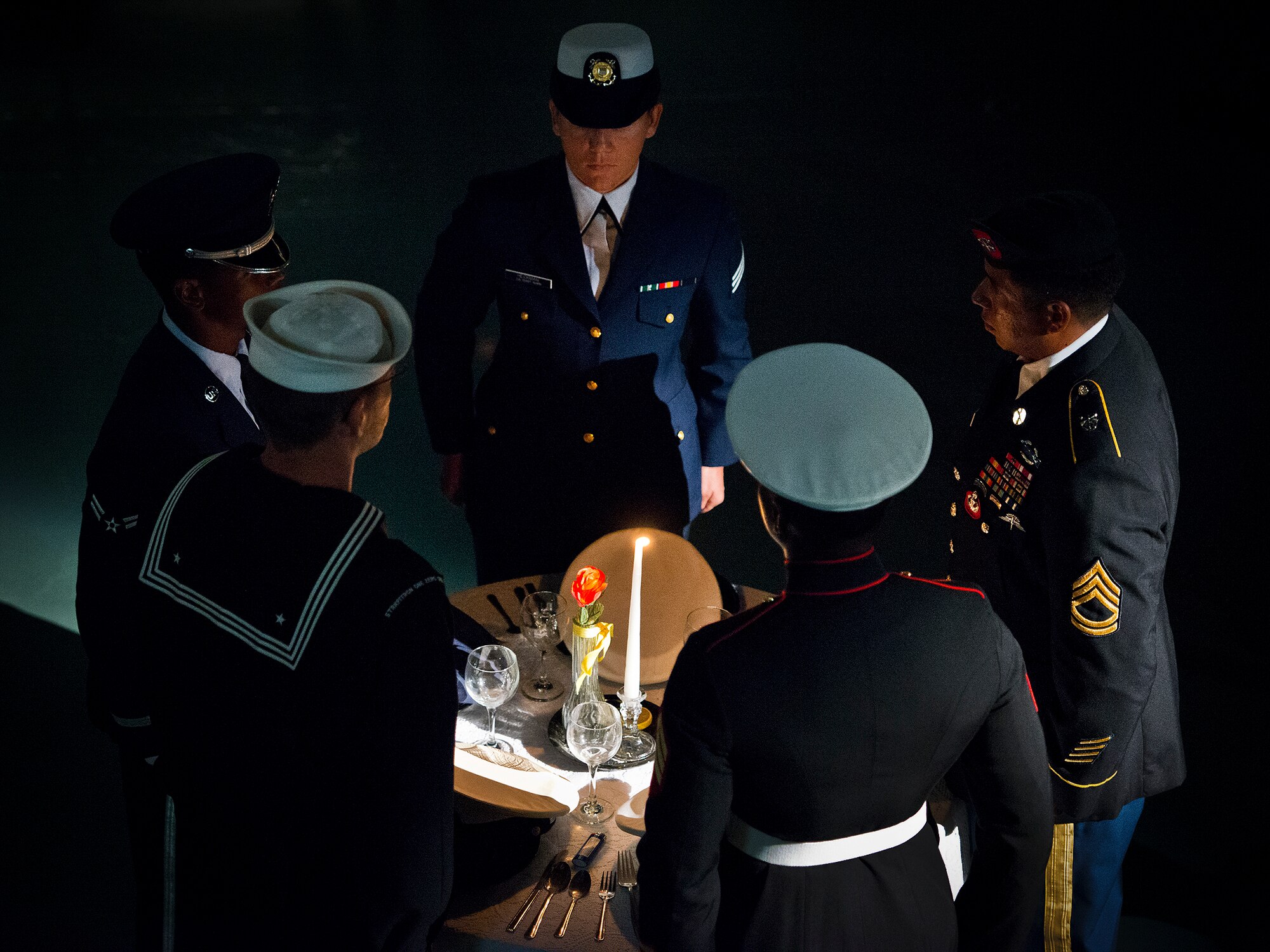 A joint service color guard prepares to set the POW/MIA table during Eglin’s POW/MIA remembrance ceremony Sept. 19 at the Air Force Armament Museum. The ceremony paid tribute to those military members who have yet to return home from defending America. The event featured tributes, guest speakers and honor guard procedures. (U.S. Air Force photo/Samuel King Jr.)