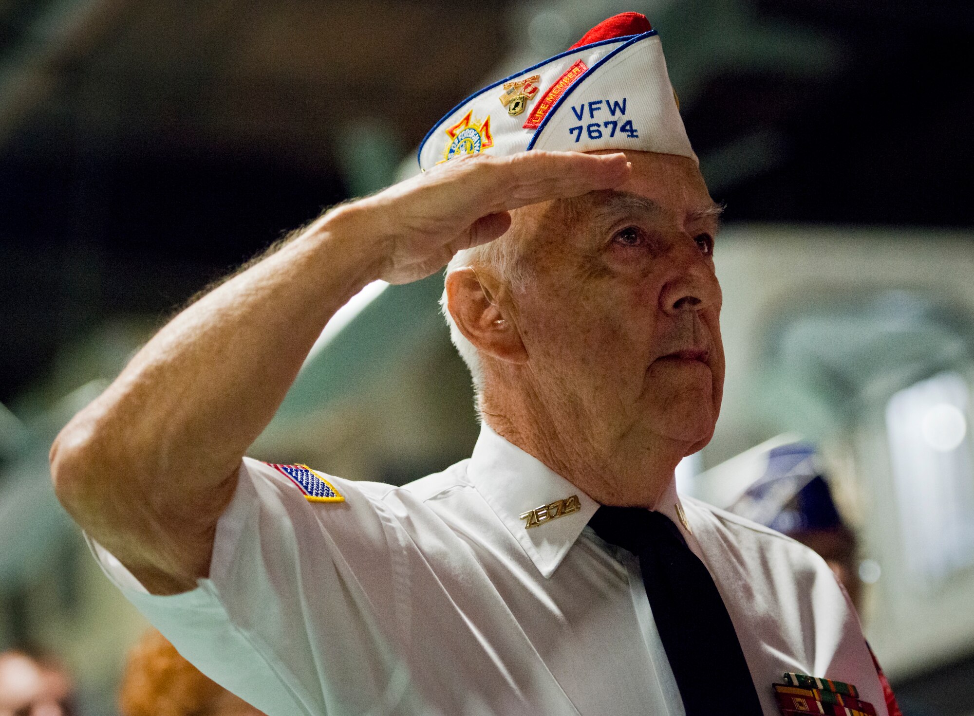 A veteran salutes during the playing of the National Anthem during Eglin’s POW/MIA remembrance ceremony Sept. 19 at the Air Force Armament Museum. The ceremony paid tribute to those military members who have yet to return home from defending America. The event featured tributes, guest speakers and honor guard procedures. (U.S. Air Force photo/Samuel King Jr.)