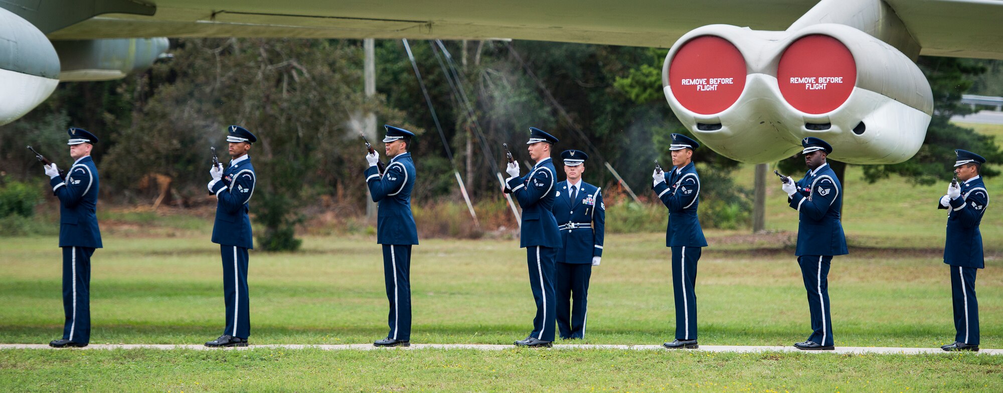 A Team Eglin Honor Guard rifle volley team fires shots during the base's POW/MIA remembrance ceremony Sept. 19 at the Air Force Armament Museum. The ceremony paid tribute to those military members who have yet to return home from defending America. The event featured tributes, guest speakers and honor guard procedures. (U.S. Air Force photo/Tech. Sgt. Jasmin Taylor)