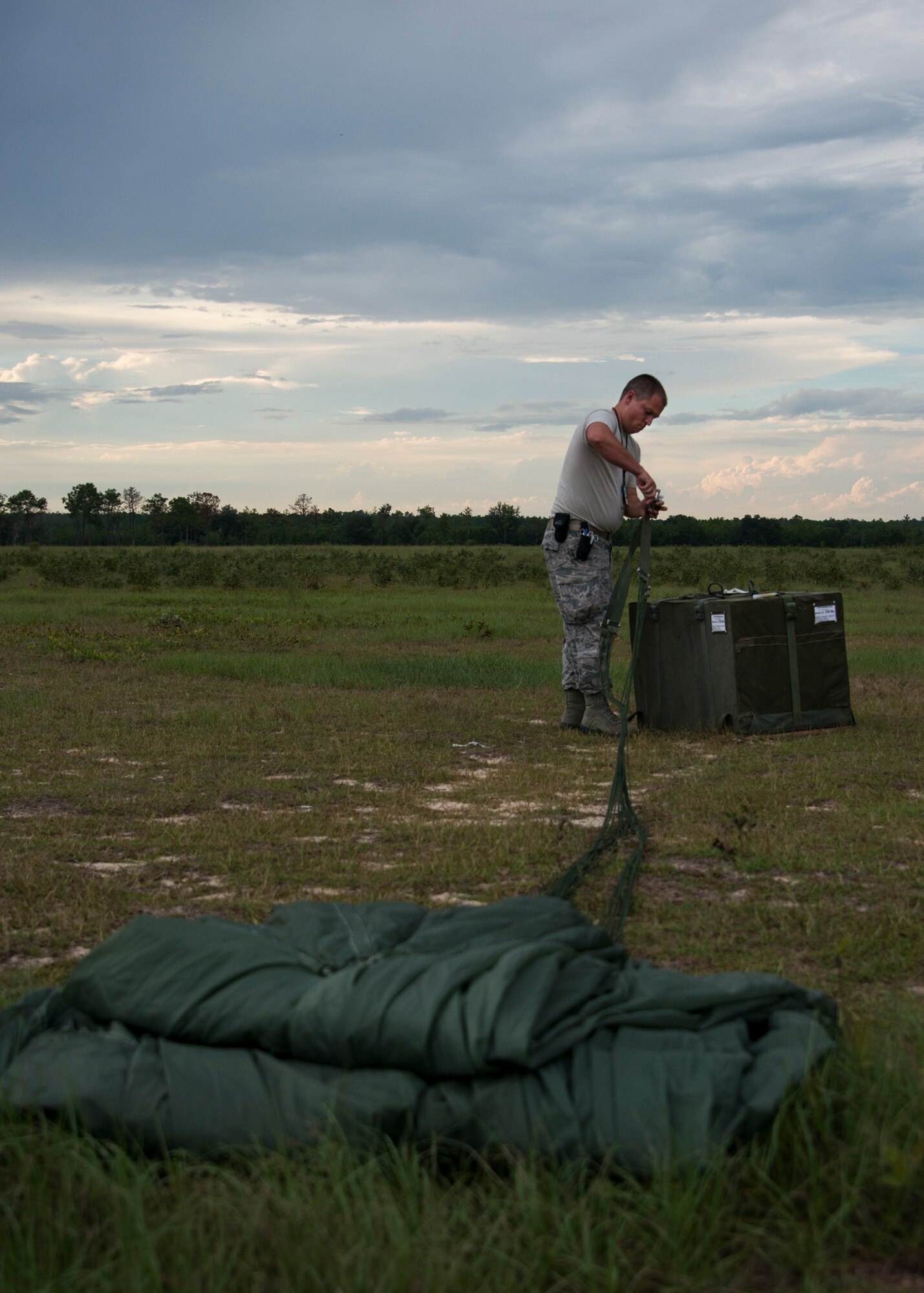 Senior Airman Kelby Ramer detaches the parachute from the low cost low altitude bundles during a training mission Sept. 15, at Duke Field, Fla.  The Airmen of the SOLRS prepare and load an average of 24 to 48 loads per week to help train pilots and loadmasters from the 5th, 6th, and the 711th Special Operations Squadron. (Air Force photo/Tech. Sgt. Jasmin Taylor)