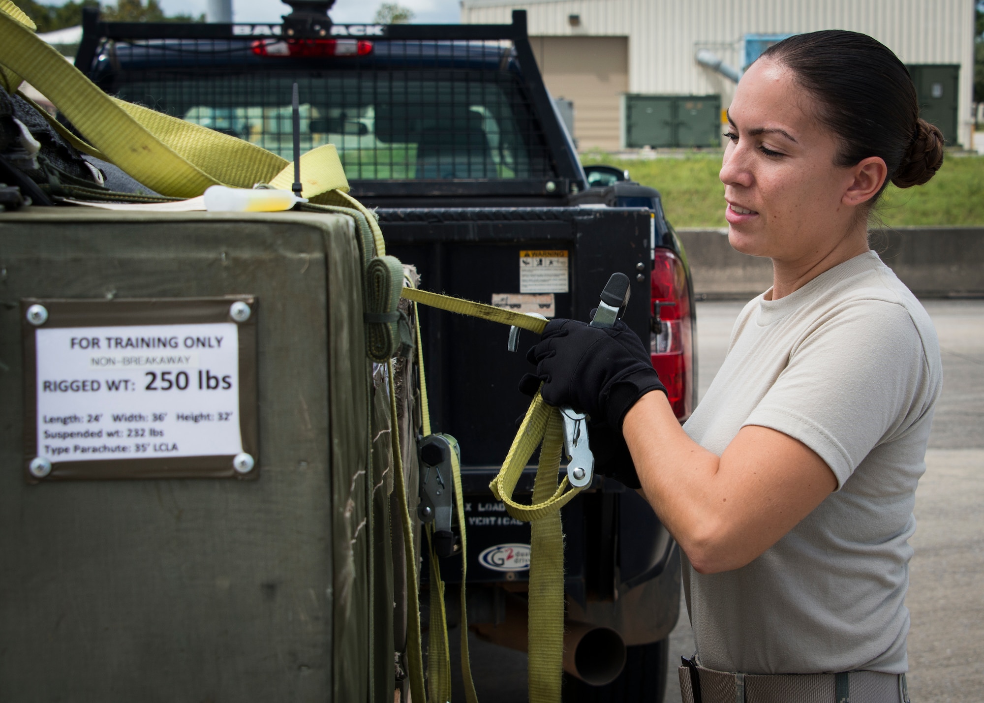 Senior Airmen Melissa Derkatz, 919th Special Operations Logistics Readiness Squadron, loads three low cost low altitude airdrop bundles into a C-145 Sept. 15, at Duke Field, Fla. The Airmen of the SOLRS prepare and load an average of 24 to 48 loads per week to help train pilots and loadmasters from the 5th, 6th, and the 711th Special Operations Squadron. (Air Force photo/Tech. Sgt. Jasmin Taylor)