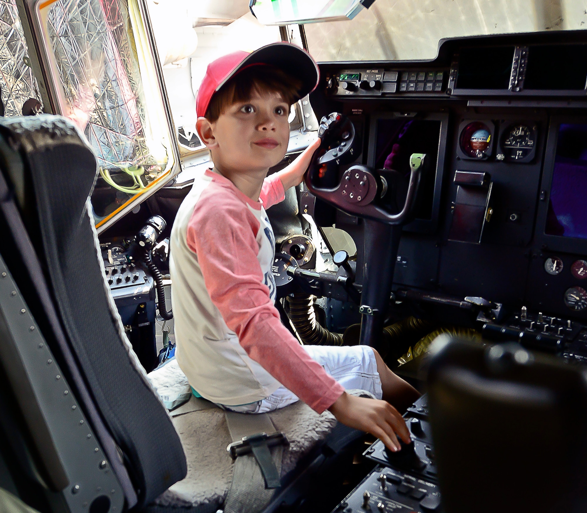 A child sits in the pilot’s chair of a C-130J Super Hercules during his tour of the aircraft at the Africa Aerospace & Defence Expo at Waterkloof Air Force Base, South Africa, Sept. 20, 2014.  The C-130 was part of a total-force team of Guard, Reserve and active-duty Soldiers and Airmen at the expo. (U.S. Air Force photo/Staff Sgt. Travis Edwards) Released