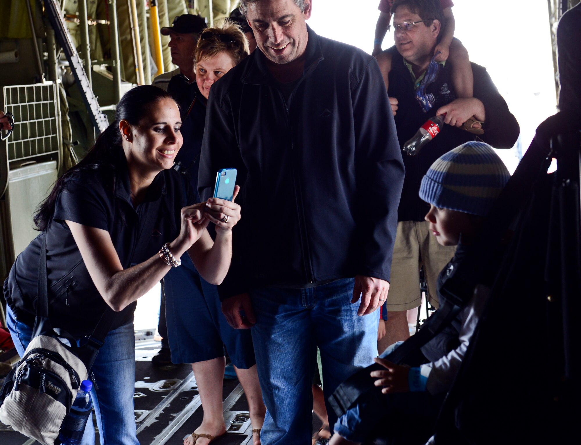 A happy mother takes a photo of her child aboard a C-130J Super Hercules at the Africa Aerospace & Defence Expo at Waterkloof Air Force Base, South Africa, Sept. 20, 2014.  The C-130 was part of a total-force team of Guard, Reserve and active-duty Soldiers and Airmen at the expo. Air show attendees were given an opportunity to view the inside of an Air Force C-130J and C-17 Globemaster III. (U.S. Air Force photo/Staff Sgt. Travis Edwards)