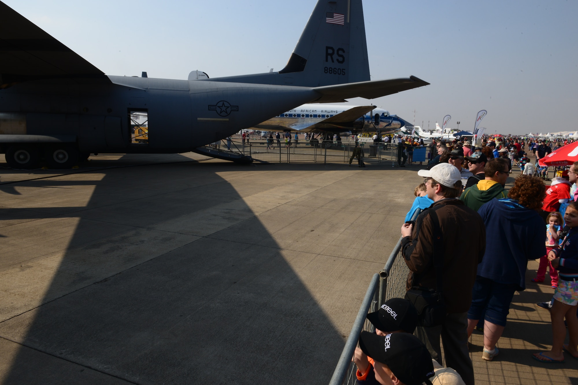 People from all over the world stand in line to view the inside of a C-130J Super Hercules at the Africa Aerospace & Defence Expo at Waterkloof Air Force Base, South Africa, Sept. 20, 2014.  The C-130 was part of a total-force team of Guard, Reserve and active-duty Soldiers and Airmen at the expo. (U.S. Air Force photo/Staff Sgt. Travis Edwards)