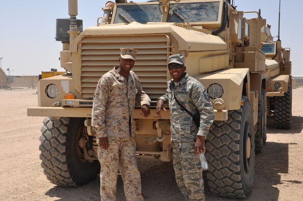 U.S. Marine Corps Sgt. Tyrone Carter, Bravo Battery, Battalion Landing Team 1st Battalion, 6th Marines, 22nd Marine Expeditionary Unit (MEU) assistant communications chief and his brother, U.S. Air Force Master Sgt. Ivory Carter, Jr., 386th Expeditionary Civil Engineer Squadron assistant chief of fire prevention pose in front of a Mine Resistant Ambush Protected vehicle at an undisclosed location in Southwest Asia. The brothers are military brats and call Miegs, Georgia home. Ivory deployed from 87th CES, Joint Base McGuire-Dix-Lakenhurst, New Jersey in support of Operation Enduring Freedom and Tyrone deployed in support of maritime security operations and theater security cooperation efforts in the U.S. 5th Fleet area of responsibility. (U.S. Air Force photo by Senior Master Sgt. Allison Day)