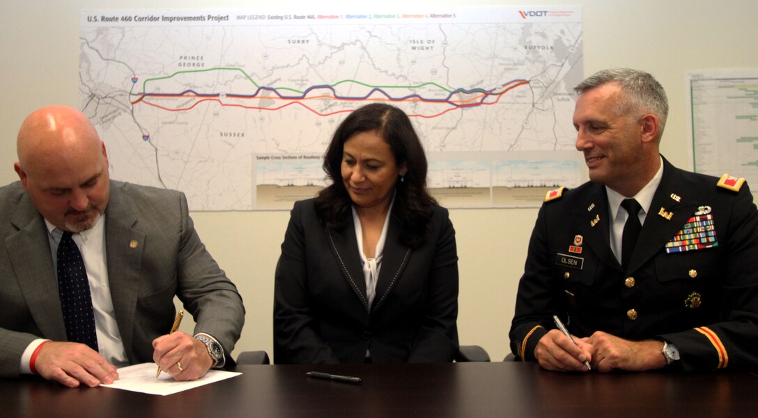 Commissioner Charlie Kilpatrick, Virginia Department of Transportation, Irene Rico, U.S. Department of Transportation Federal Highway Administration division administrator, and Col. Paul Olsen, commander of U.S. Army Corps of Engineers' Norfolk District, sign the U.S. Route 460 draft Supplemental Environmental Impact Statement, Sept. 18, in Suffolk, Virginia.

