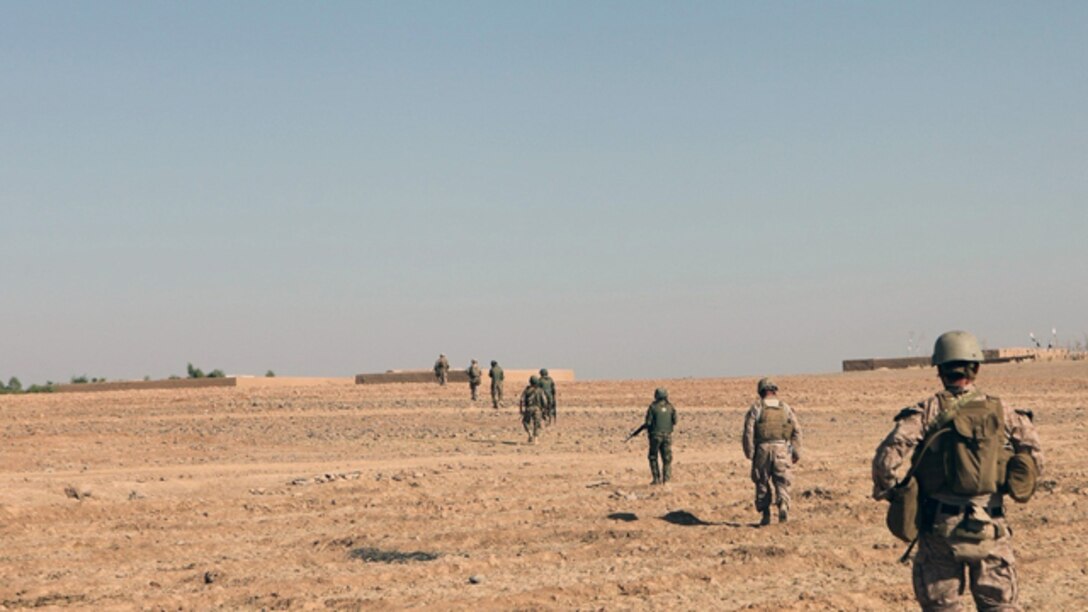 Marines and sailors with Bravo Company, 1st Battalion, 2nd Marine Regiment, patrol with Afghan National Army counterparts during a security operation in Helmand province, Sept. 9, 2014. During the 72-hour operation, Marines and ANA soldiers conducted dismounted patrols on foot to search nearby compounds for weapons and lethal aid. (U.S. Marine Corps photo by Cpl. Cody Haas/ Released)