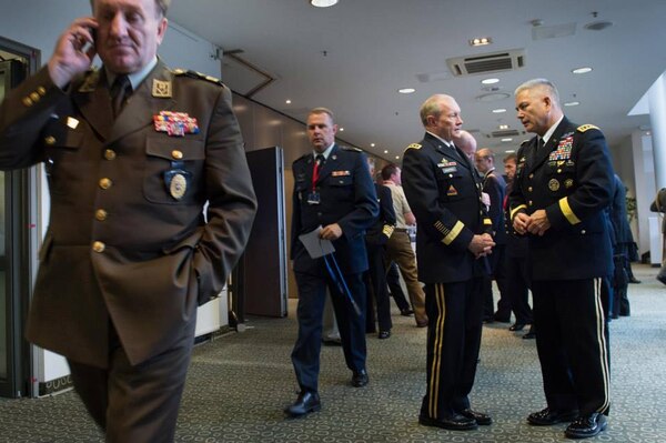 Army Gen. Martin E. Dempsey, chairman of the Joint Chiefs of Staff, center, talks with Army Gen. John Campbell, commander of the International Security Assistance Force in Afghanistan, right, between sessions of the NATO Military Committee conference in Vilnius, Lithuania, held Sept. 20-21, 2014.