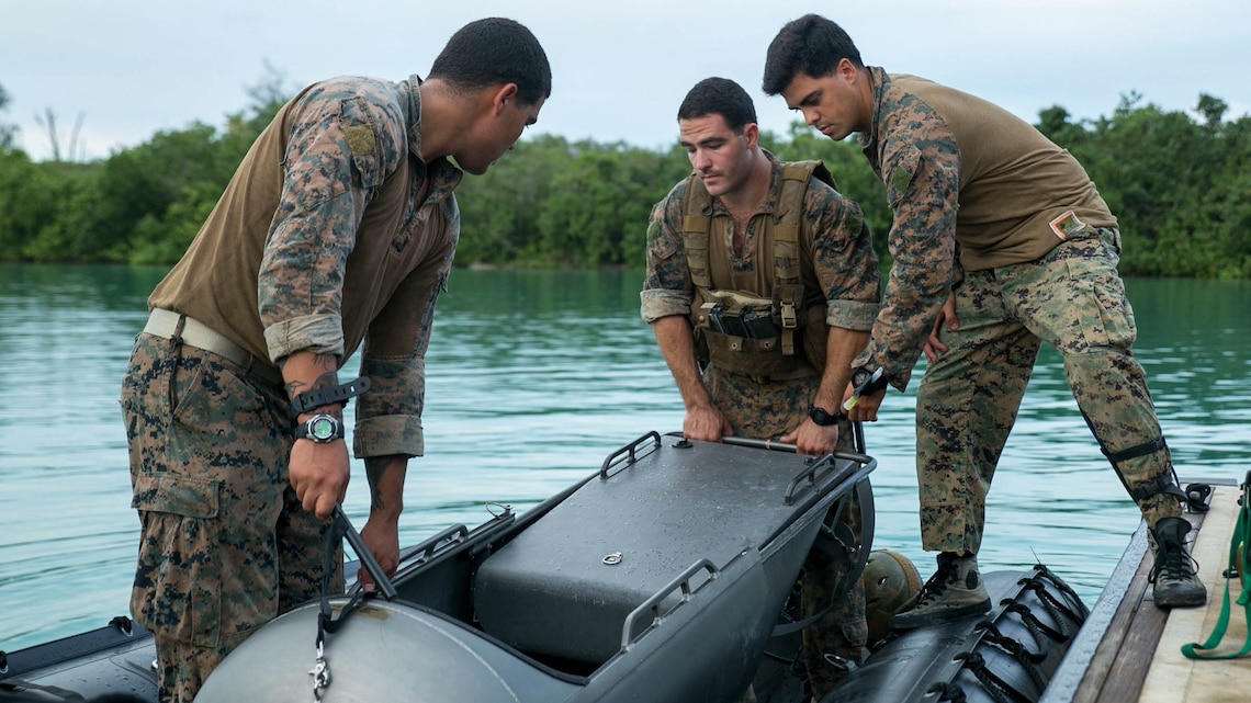 Marines load a diver propulsion device into a combat rubber raiding craft Sept. 20 at U.S. Naval Base Guam during Exercise Valiant Shield 2014. The device aids the Marines conducting night infiltration. Valiant Shield is a U.S.-only exercise integrating Navy, Air Force, Army, and Marine Corps assets, offering real-world joint operational experience to develop capabilities, which provide a full range of options to defend U.S. interests and those of its allies and partners.  The Marines are reconnaissance men with 3rd Reconnaissance Battalion, 3rd Marine Division, III Marine Expeditionary Force. 