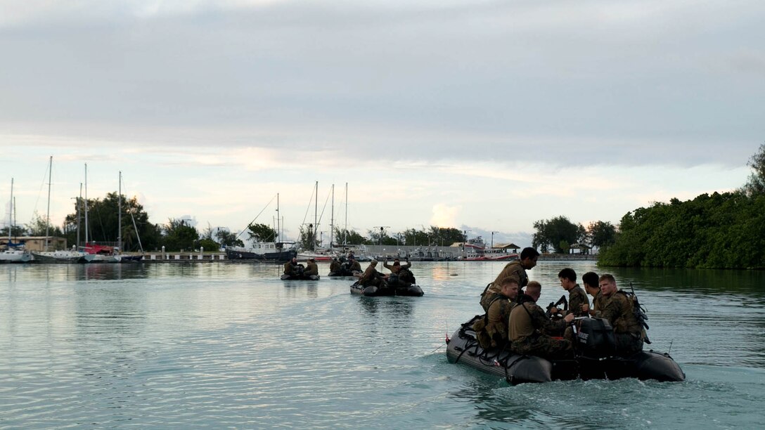 Marines ride out on a combat rubber raiding craft as they prepare to conduct night infiltration Sept. 20 at U.S. Naval Base Guam during Exercise Valiant Shield 2014.  The Marines will use a diver propulsion device to swiftly come ashore. Valiant Shield is a U.S.-only exercise integrating Navy, Air Force, Army, and Marine Corps assets, offering real-world joint operational experience to develop capabilities which provide a full range of options to defend U.S. interests and those of its allies and partners.  The Marines are reconnaissance men with 3rd Reconnaissance Battalion, 3rd Marine Division, III Marine Expeditionary Force. (U.S. Marine Corps photo by Cpl. Lena Wakayama/Released)