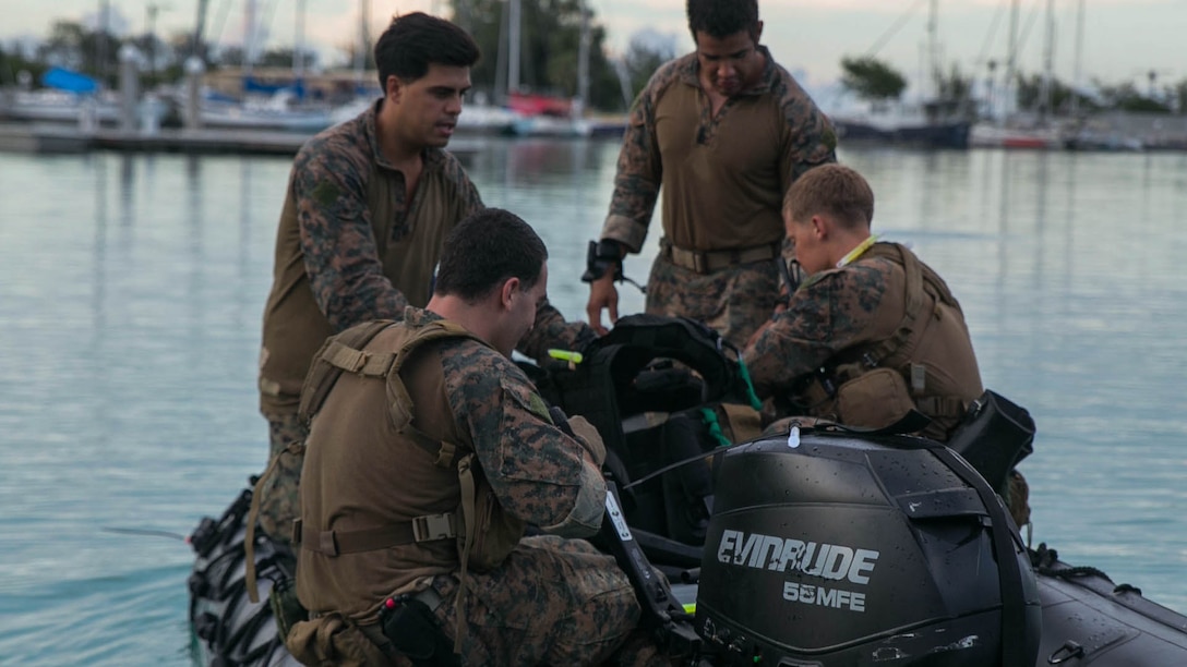 Marines ride out on a combat rubber raiding craft as they prepare to conduct night infiltration Sept. 20 at U.S. Naval Base Guam during Exercise Valiant Shield 2014. Once night falls, the Marines will use a diver propulsion device to swiftly come ashore. Valiant Shield is a U.S.-only exercise integrating Navy, Air Force, Army, and Marine Corps assets, offering real-world joint operational experience to develop capabilities that provide a full range of options to defend U.S. interests and those of its allies and partners.  The Marines are reconnaissance men with 3rd Reconnaissance Battalion, 3rd Marine Division, III Marine Expeditionary Force. (U.S. Marine Corps photo by Cpl. Lena Wakayama/Released)