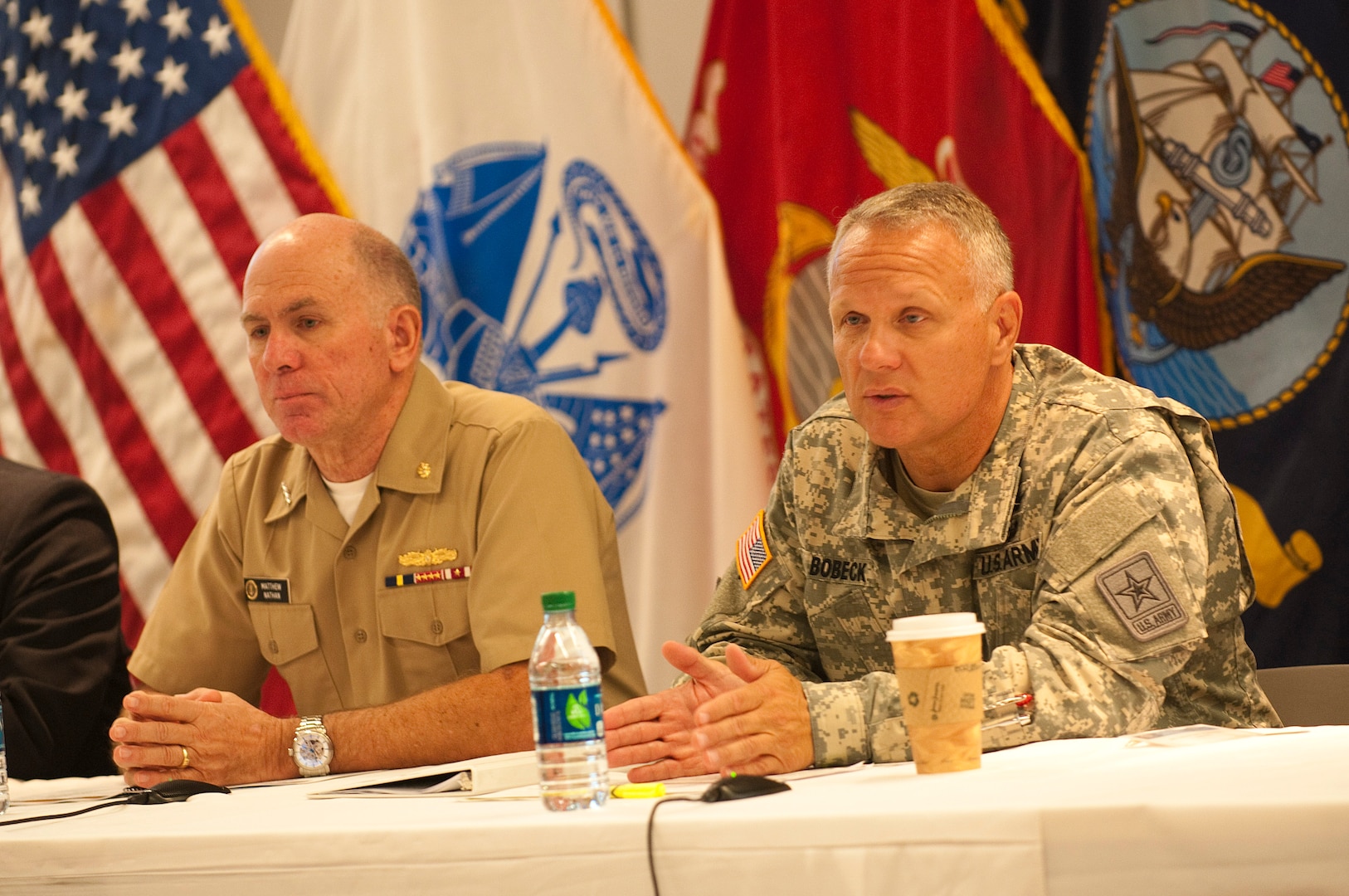 Army Brig. Gen. Michael Bobeck, right, special assistant to the director of the Army National Guard, along with Navy Vice Adm. Matthew Nathan, left, surgeon general of the Navy, speaks during a panel discussion about the mental health challenges facing the Army Guard during a Psychological Health and Resiliance Summit, Sept. 18, 2014 in Falls Church,Va. The Defense Centers for Excellence for Psychological Health and Traumatic Brain Injury spearheaded the summit, which allowed leaders from across the Department Of Defense to discuss the way ahead for addressing psychological health issues and resilience across the force. (Army National Guard photo by Staff Sgt. Darron Salzer, National Guard Bureau)(Released)