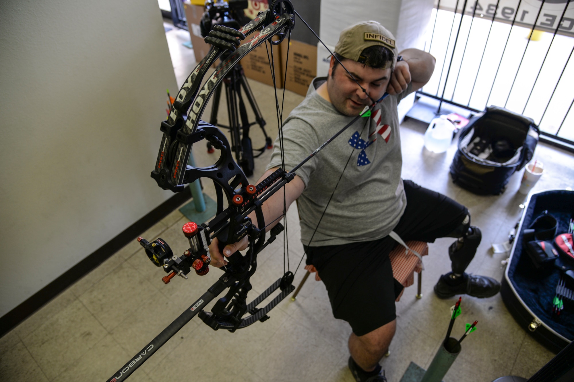 Staff Sgt. Seth Pena readies his compound bow to strike a target 25 meters away Sept. 14, 2014, at a local archery facility in San Antonio. Pena is vying for a spot on the Air Force team competing at the 2014 Warrior Games, taking place from Sept. 28 to Oct. 4, in Colorado Springs, Colorado. Pena is a former tactical control air party member and is now assigned to the 59th Medical Wing's Airman Medical Transition Unit. (U.S. Air Force photo/Senior Airman Michael Ellis)