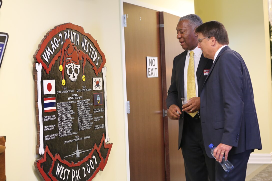 Cornell Wilson, left, stands with North Carolina Governor Pat McCrory as they stop to read a sign in the hallway of Miller’s Landing at Marine Corps Air Station Cherry Point, N.C., Sept. 16, 2014. Wilson is a retired Marine Corps major general and current military affairs advisor to Governor McCrory.