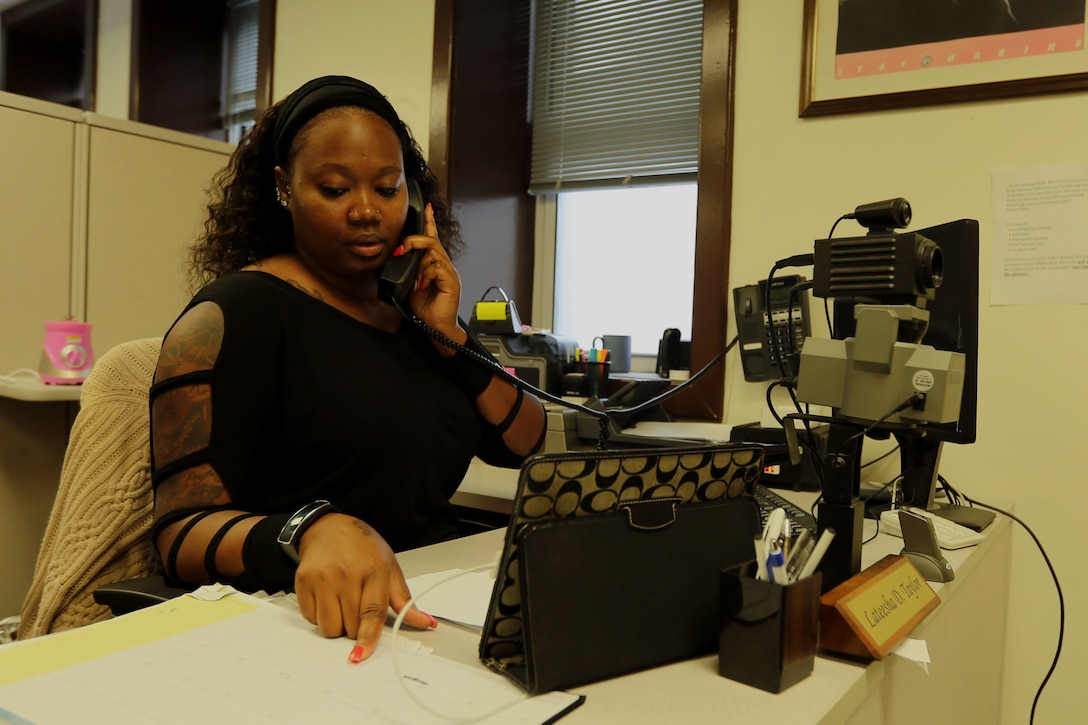 Lateesha D. Taylor answers a call from a customer inquiring for information about an early retirement at the Defense Enrollment Eligibility Reporting System and Real-Time Automated Personnel Identification System office Sept. 22, 2014, at Marine Corps Air Station Cherry Point N.C. Cherry Point’s DEERS and RAPIDS office recently received the Marine Corps Personnel and Readiness Site Excellence Award from the Office of the Under Secretary of Defense Sept. 17 for unwavering dedication to duty and outstanding performance by a team of Marine and civilian Department of Defense employees. Taylor is a human resource assistant and has worked with the office for more than four years.