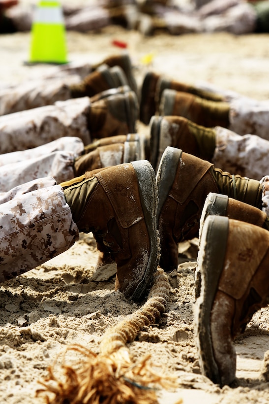 The Marines of Marine Unmanned Aerial Vehicle Squadron 2 lay face down before the start of a tug of war match during Marine Corps Air Station Cherry Point’s Combined Federal Campaign kickoff Sept. 19, 2014. Six teams competed in a double elimination tournament for the title of the CFC Cup champions.