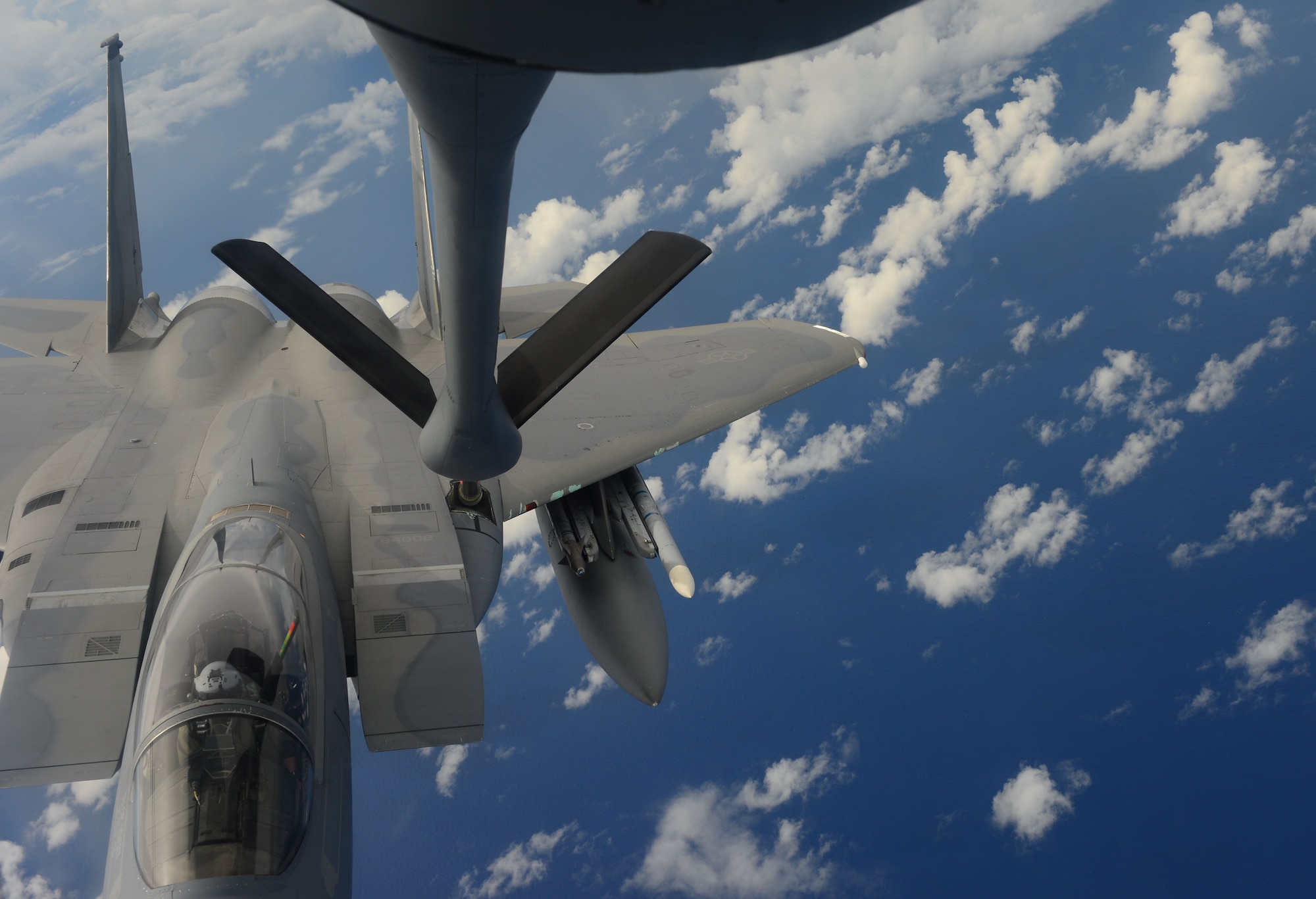 A U.S. Air Force F-15 Eagle from the 44th Fighter Squadron refuels from a KC-135 Stratotanker from the 909th Refueling Squadron while conducting joint air operations during Valiant Shield 2014, Andersen Air Force Base, Guam, Sept. 19, 2014. Valiant Shield is a U.S.-only exercise integrating an estimated 18,000 Navy, Air Force, Army and Marine Corps personnel, more than 200 aircraft and 19 surface ships.The exercise offers real-world joint operational experience to develop capabilities that provide a full range of options to defend U.S. interests and those of its allies and partners. (U.S. Navy photo by Mass Communication Specialist (SW) 1st Class Carla Burdt/Released)