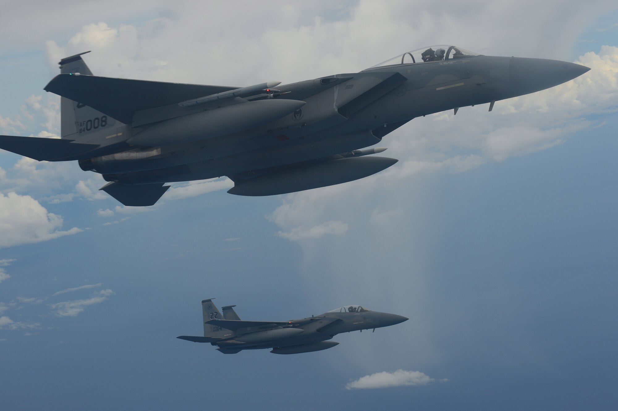 Two U.S. Air Force F-15 Eagles from the 44th Fighter Squadron wait alongside a KC-135 Stratotanker (not pictured) before moving into position for refueling while conducting joint air operations during Valiant Shield 2014, Andersen Air Force Base, Guam, Sept. 19, 2014. Valiant Shield is a U.S.-only exercise integrating an estimated 18,000 Navy, Air Force, Army and Marine Corps personnel, more than 200 aircraft and 19 surface ships.The exercise offers real-world joint operational experience to develop capabilities that provide a full range of options to defend U.S. interests and those of its allies and partners. (U.S. Navy photo by Mass Communication Specialist (SW) 1st Class Carla Burdt/Released)
